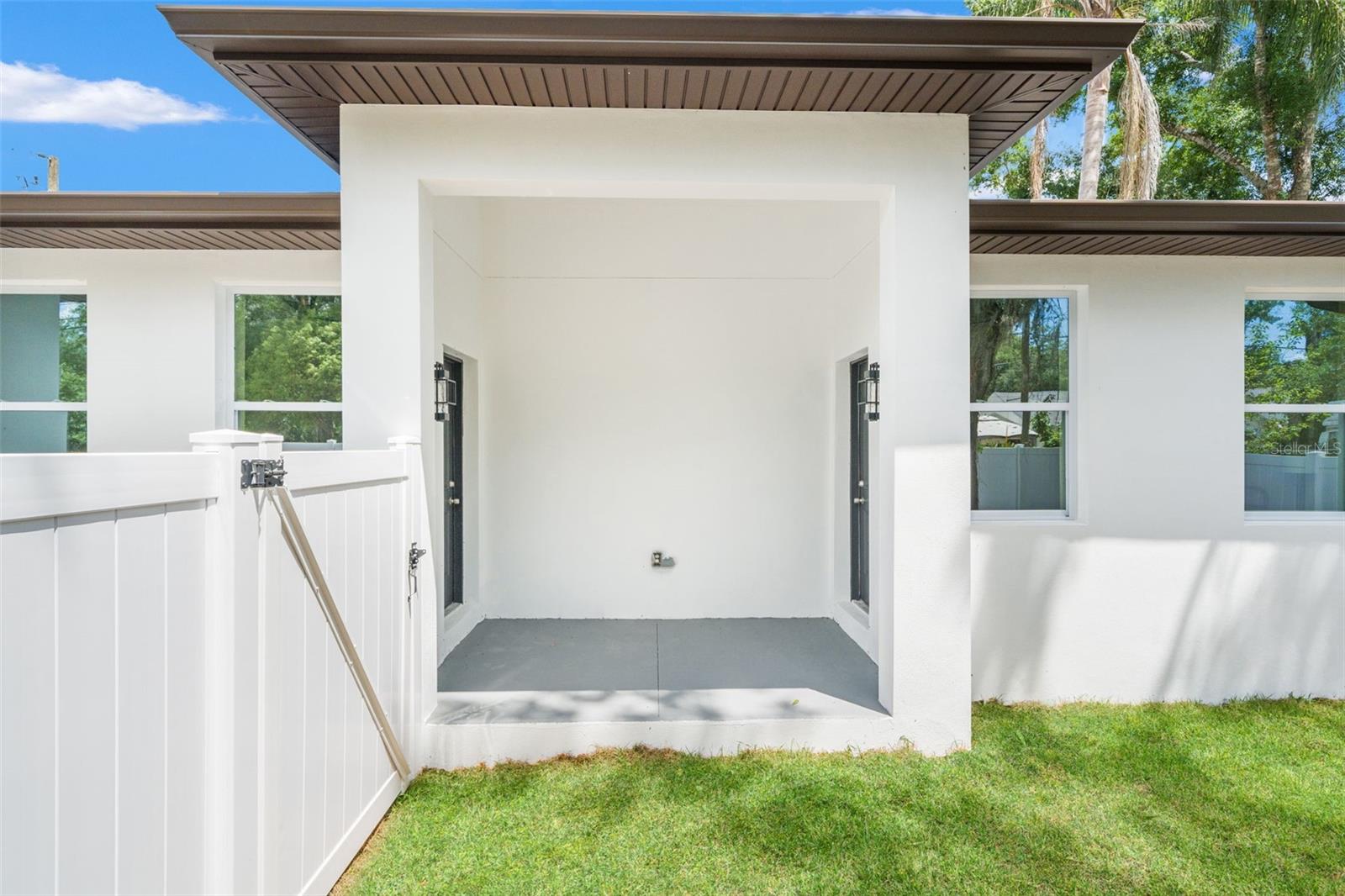 side porch with doors to both primary suites