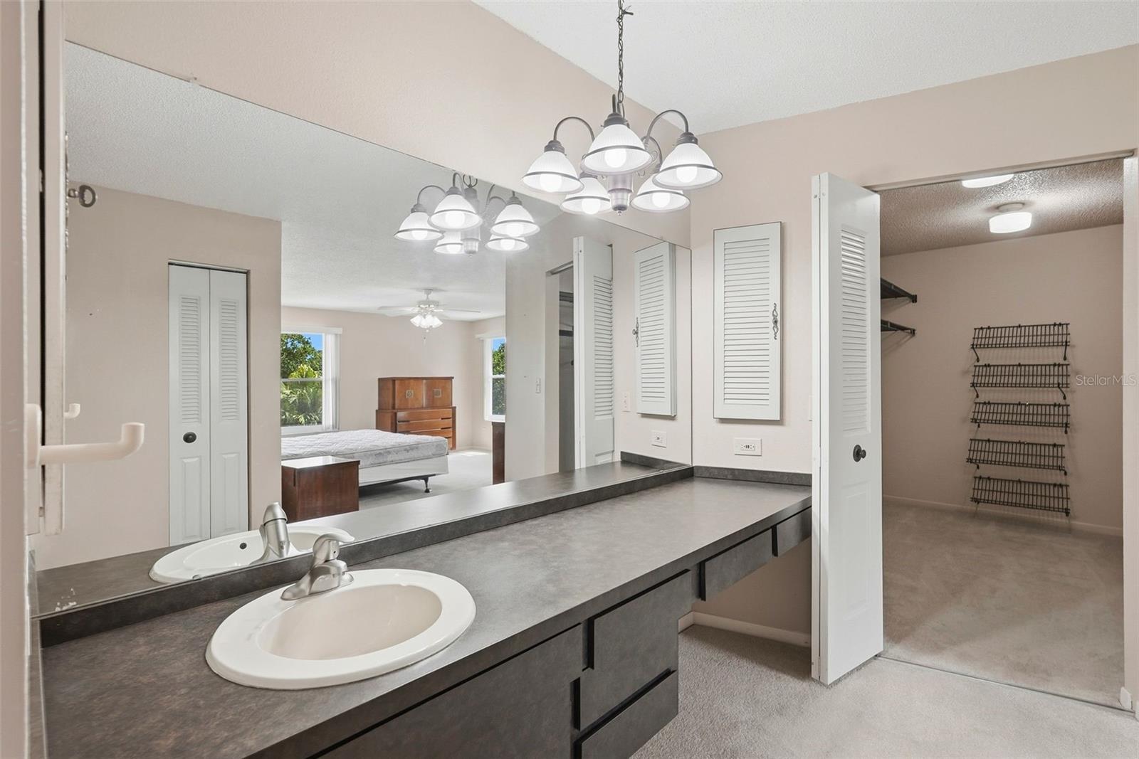 Bathroom in Primary Bedroom and view into the walk in closet.