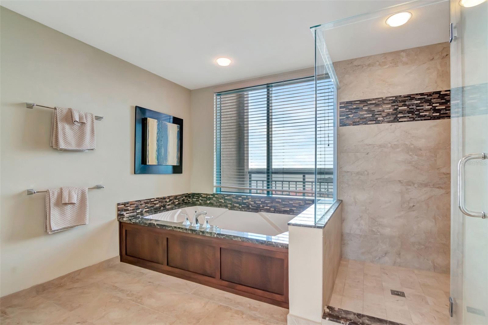 Massive primary bath with large tub with views of intercoastal