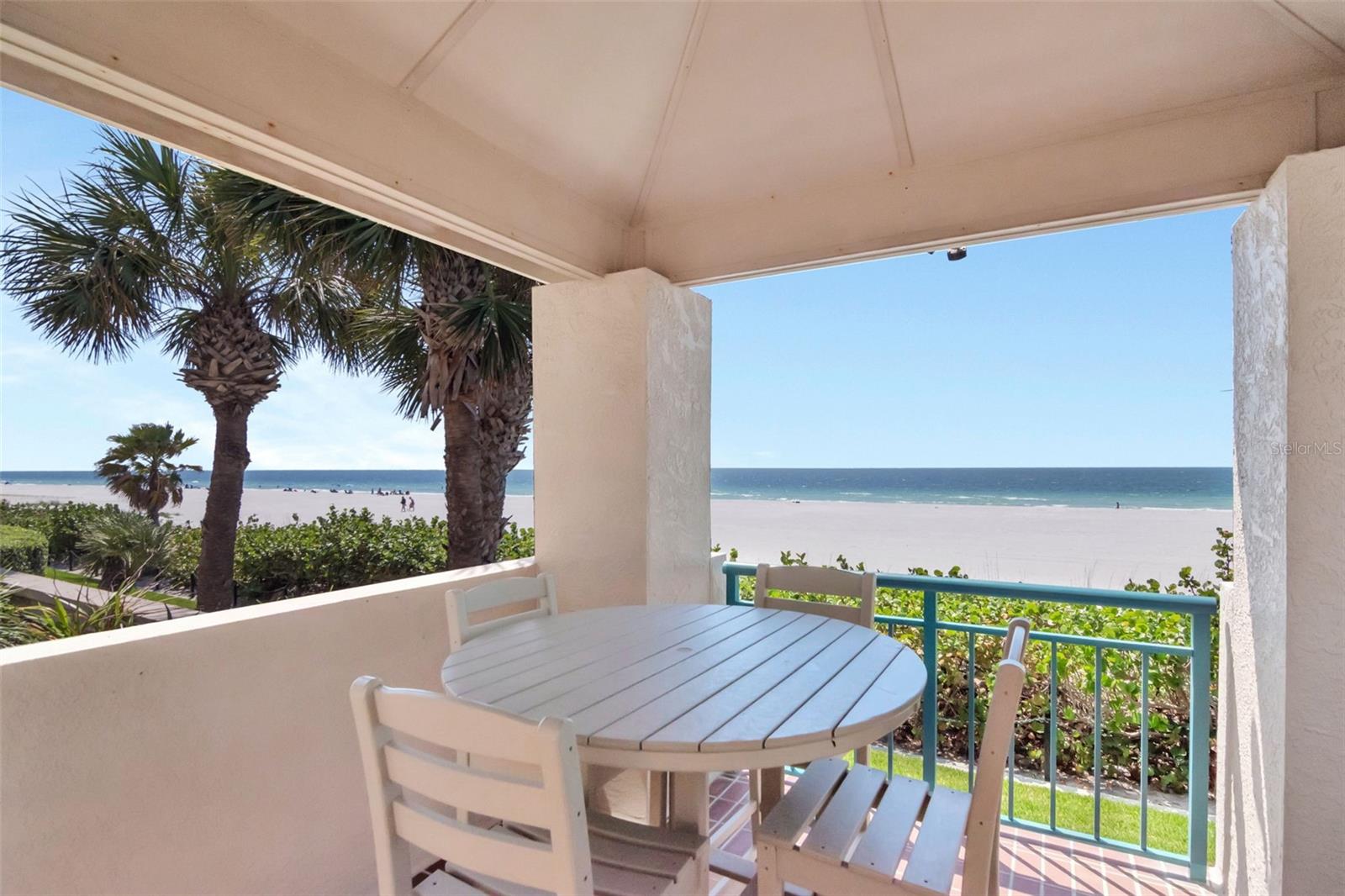 Covered outside eating area by pool overlooking beach