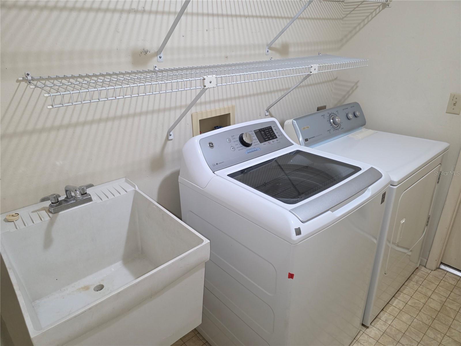 INSIDE LAUNDRY ROOM WITH A WASH TUB