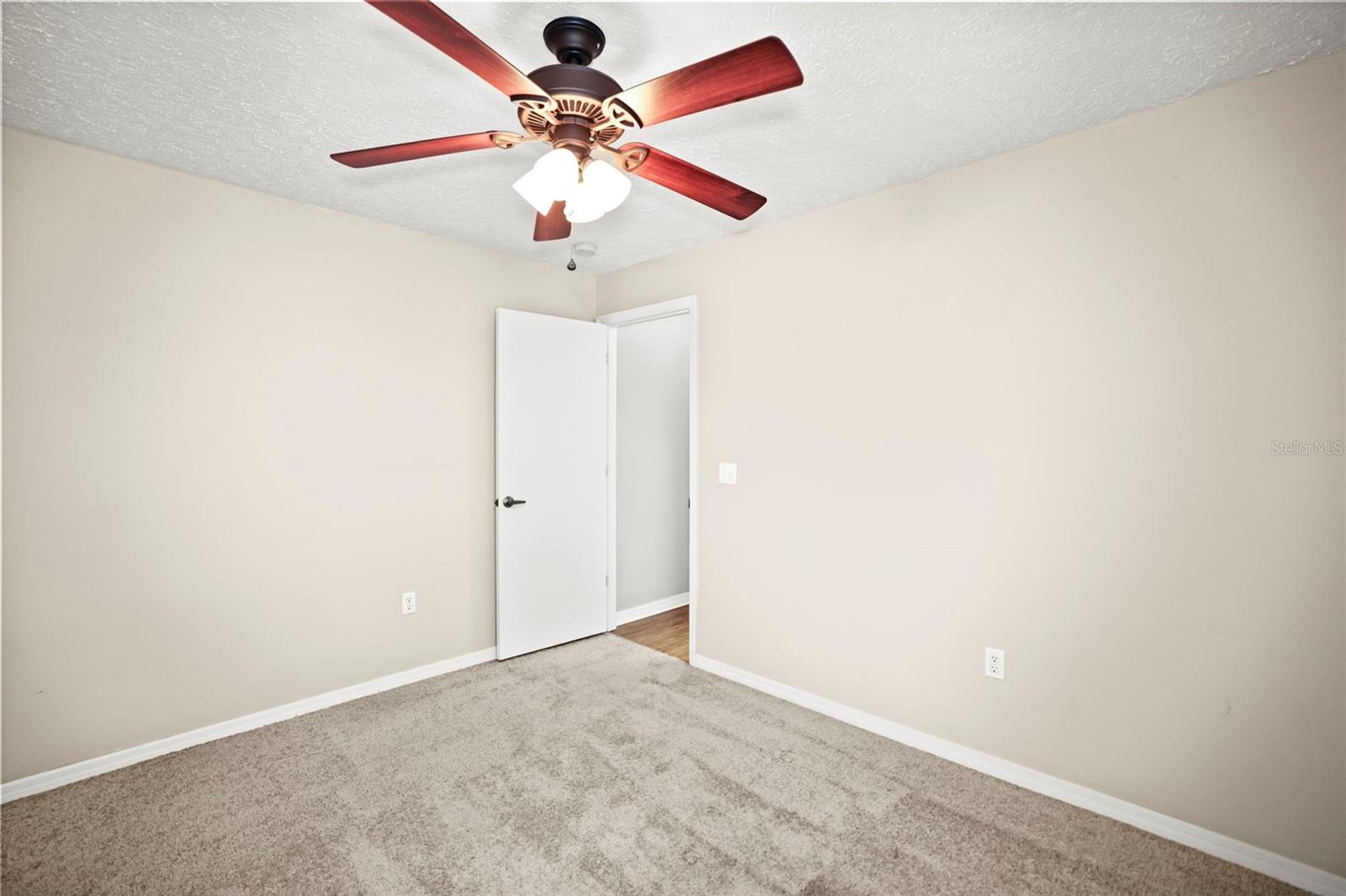 Bedroom 2 with carpet and ceiling fan.