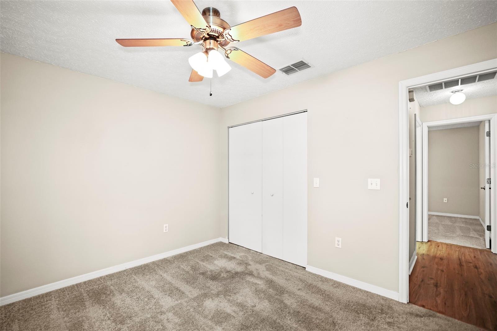 Bedroom 3 with built in closet, window allowing natural light and ceiling fan