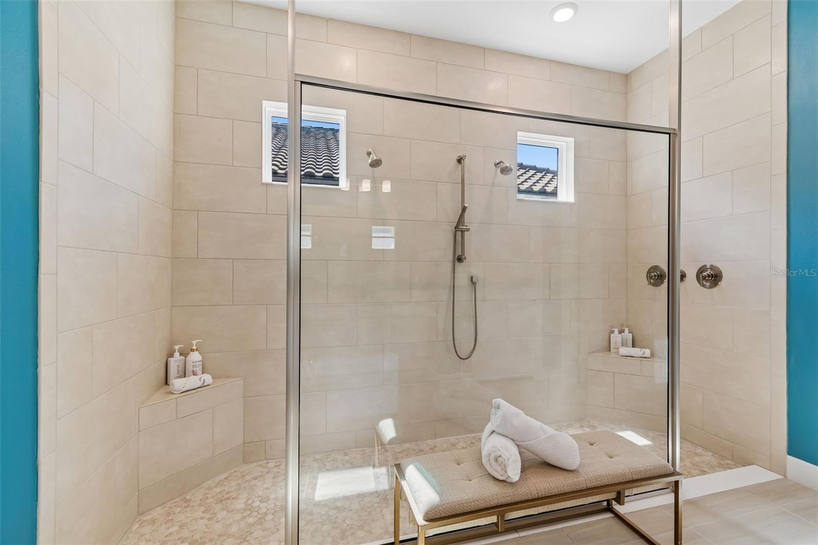 Large walk-in shower with tile to ceiling