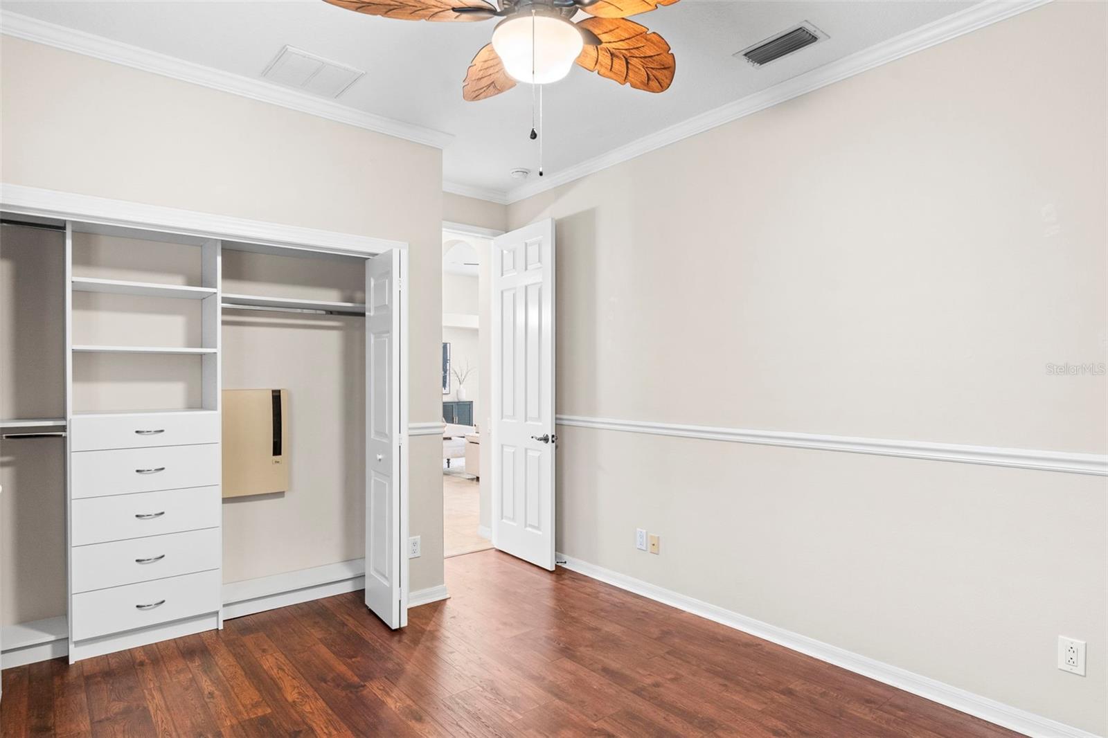 All secondary bedrooms have new luxury laminate flooring, crown molding, and built-in closet systems