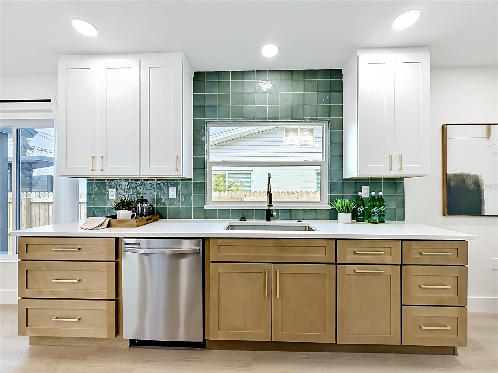 Kitchen with Two Toned Cabinet, Pull-Out Drawers and Decorative Tile