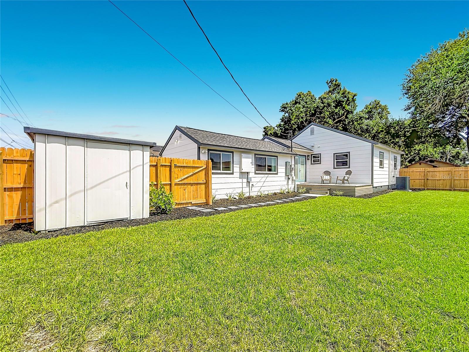 Large Fully Fenced Backyard with Fresh Landscaping, Custom Deck, Double Gate with Alley Access