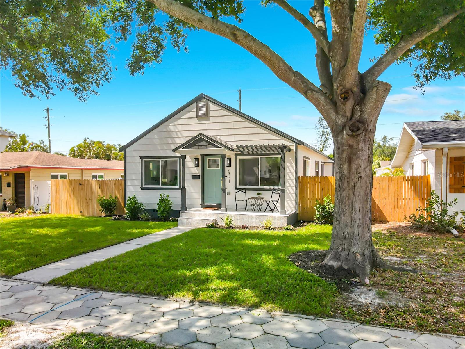 Welcoming Front Porch with Custom Pergola and Decorative Tile