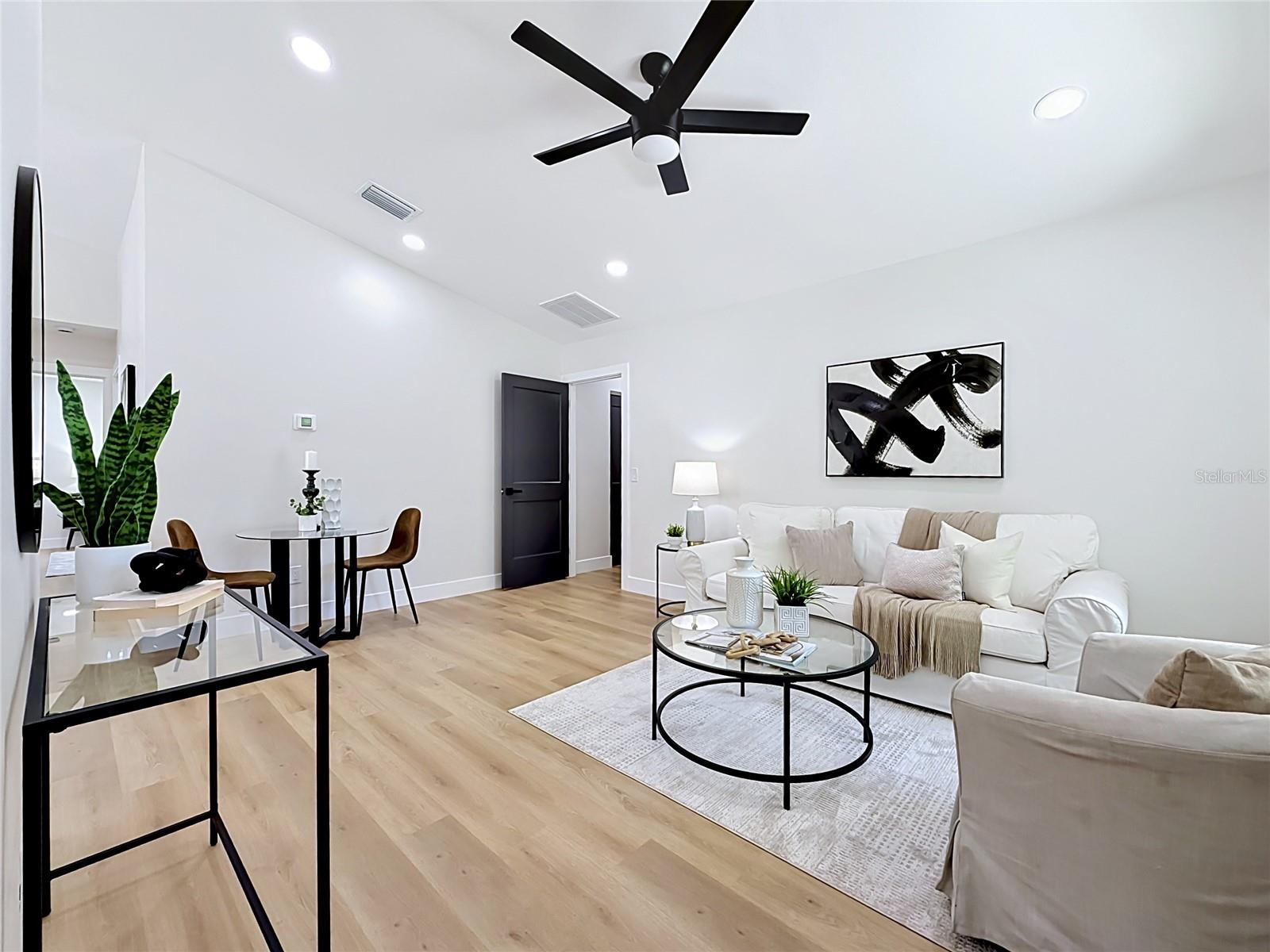 Living Room with Door Leading to Laundry Room and Garage
