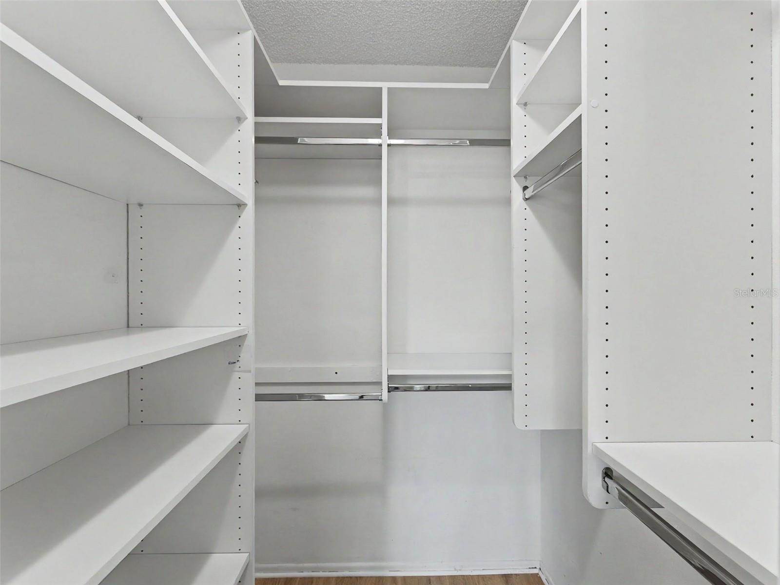 Custom closet organizers in both bedrooms