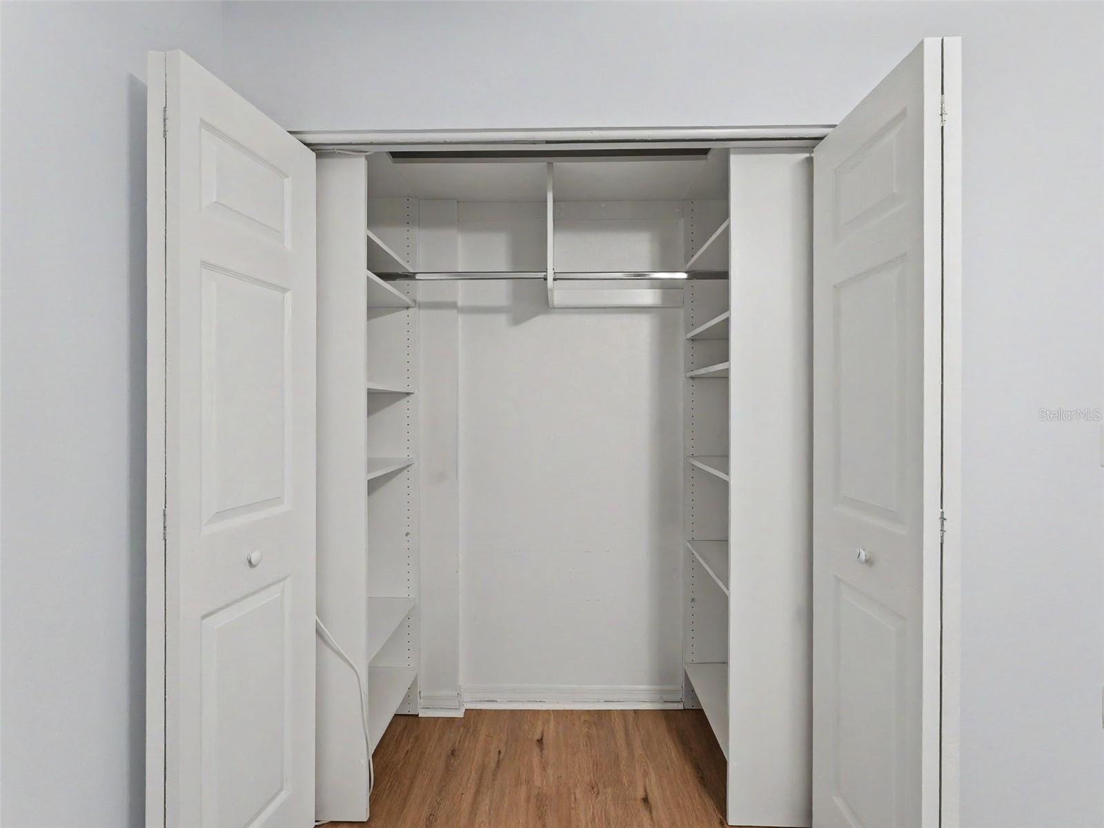 Custom closet organizers in both bedrooms