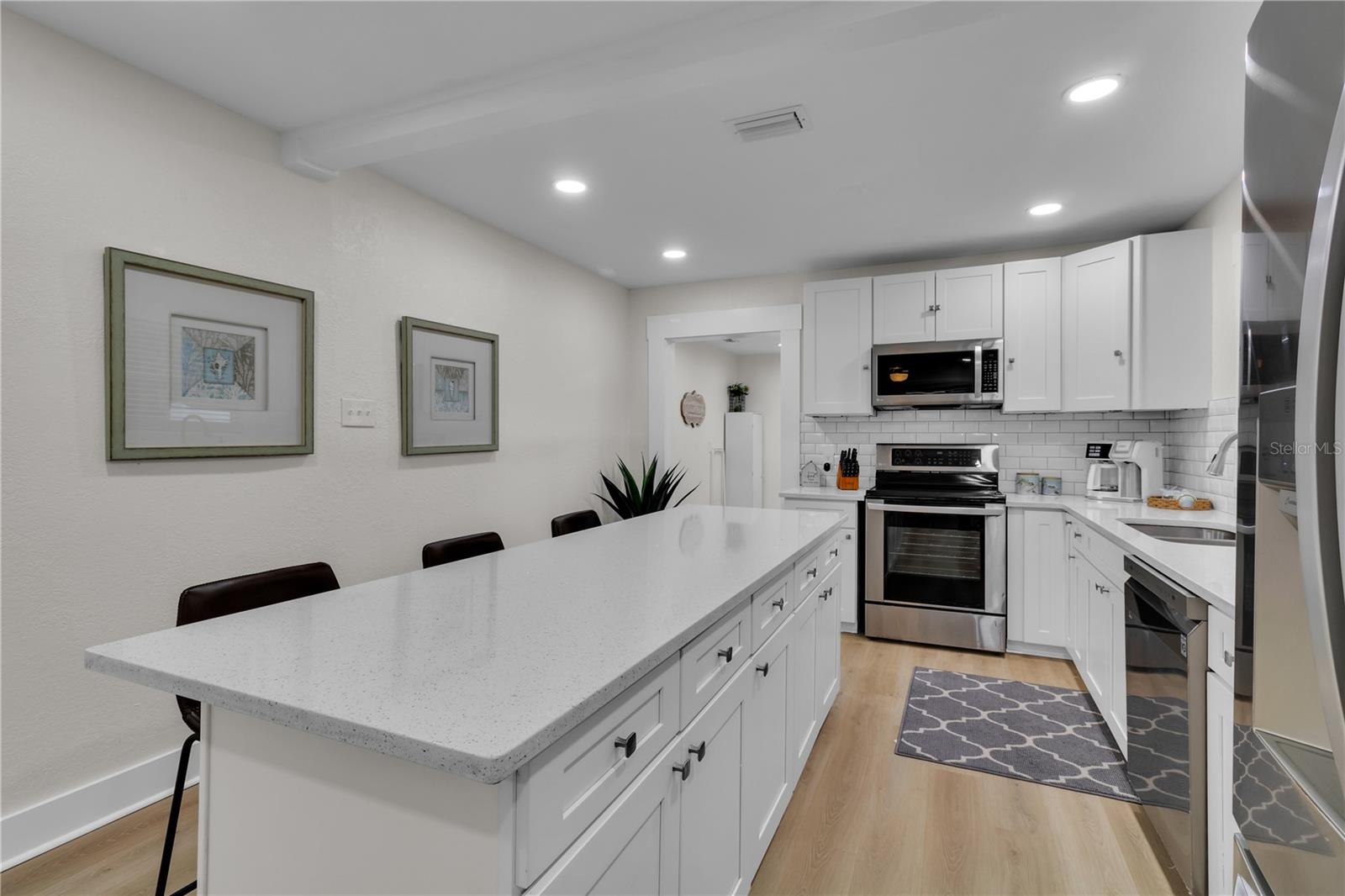 A spacious kitchen with a long island, perfect for entertaining and gathering with guests.