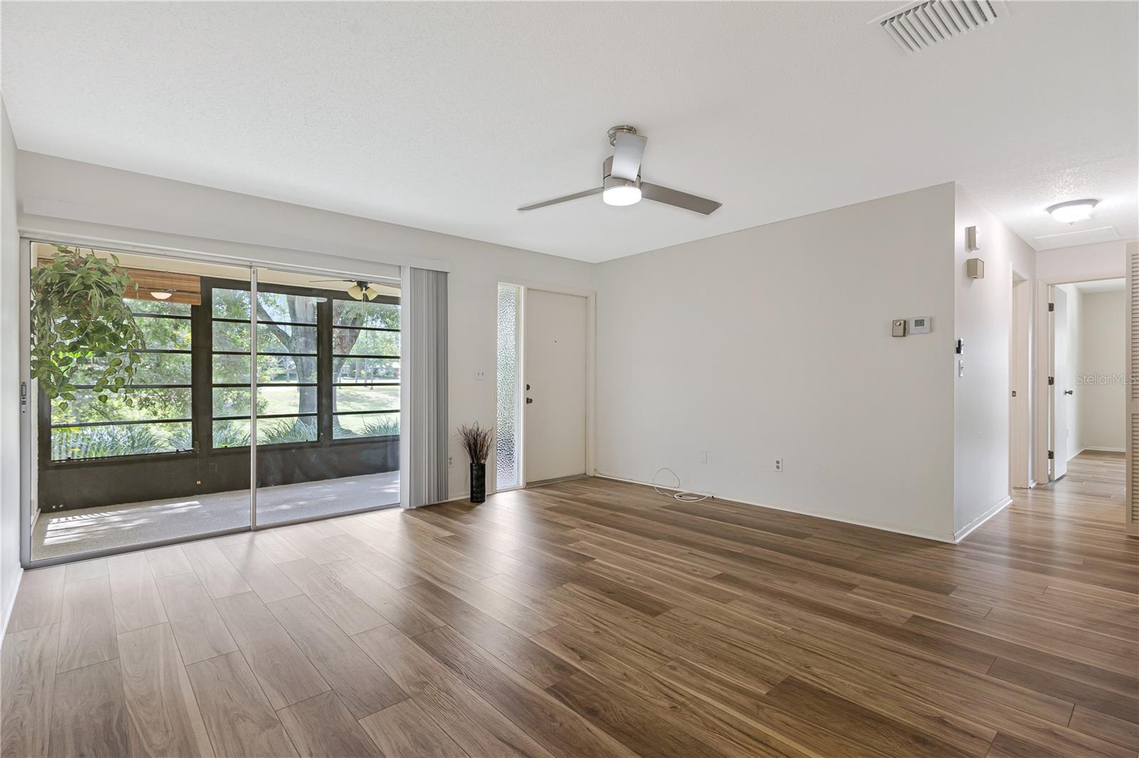 Luxury Vinyl Flooring in the living room and modern remote-control ceiling fan