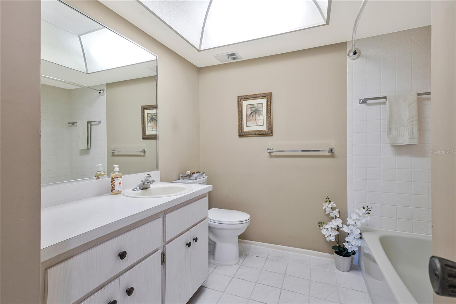 Guest Bath with tub. Hallway has a separate utility closet in Hallway