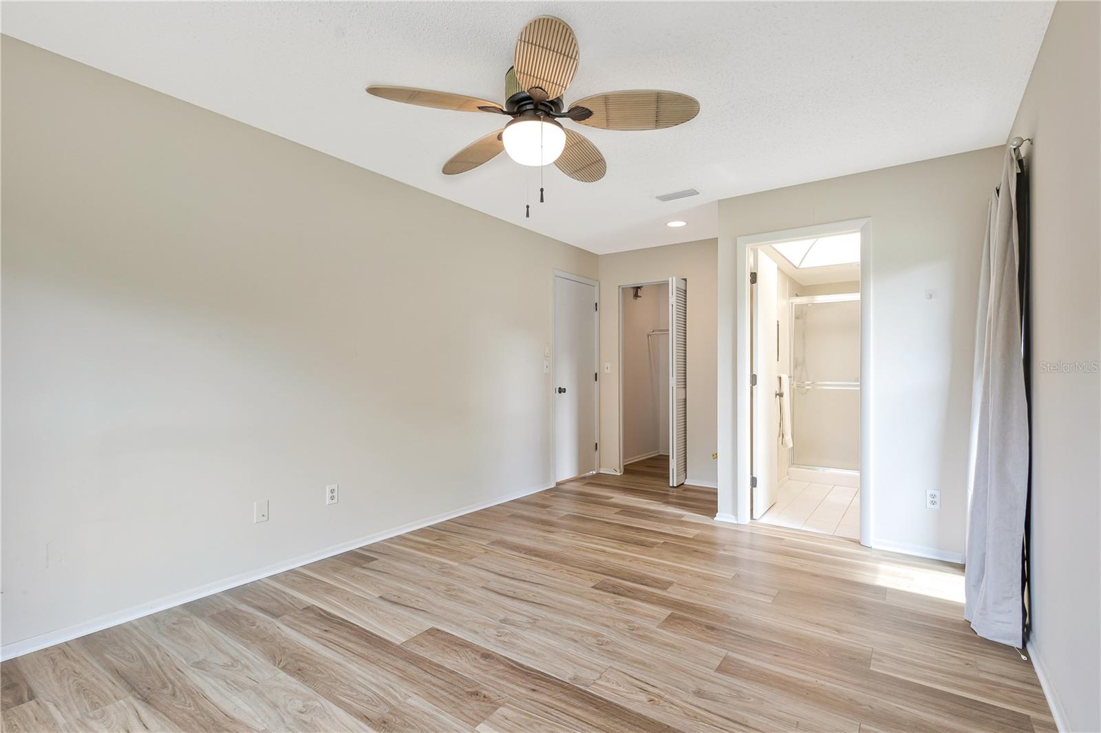 Primary Bedroom with walk in closet and the ensuite bath