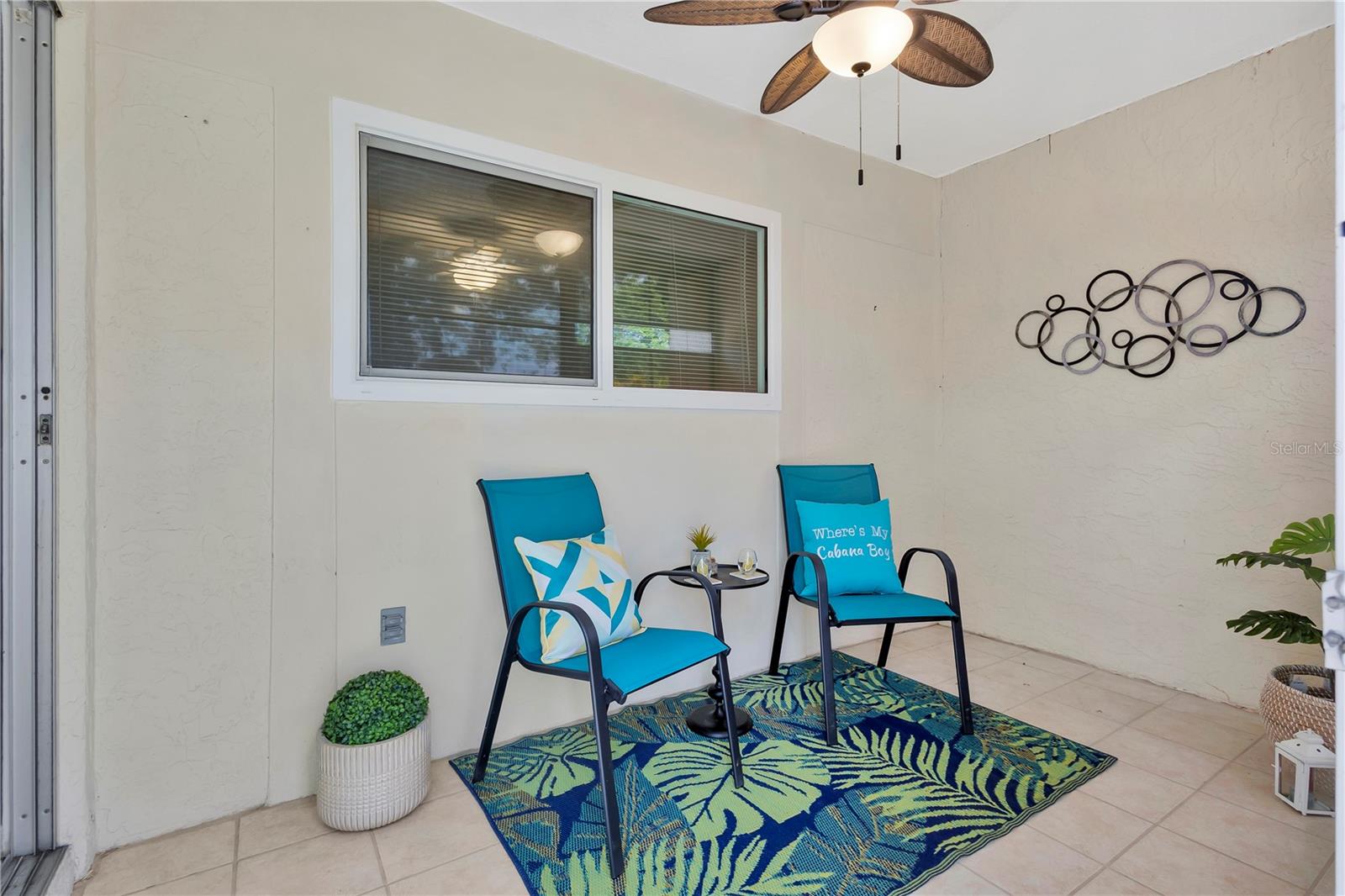Sliding door leading to your private lanai with ceiling fan and nature views