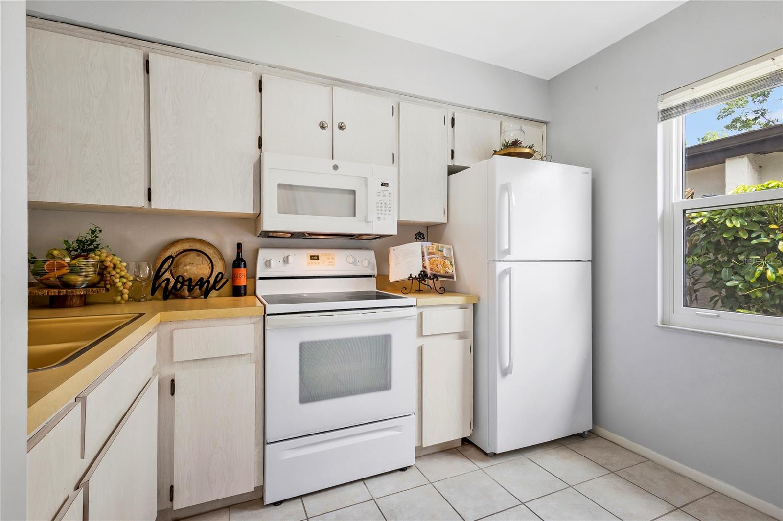 Kitchen with white appliance and window that allows natural light