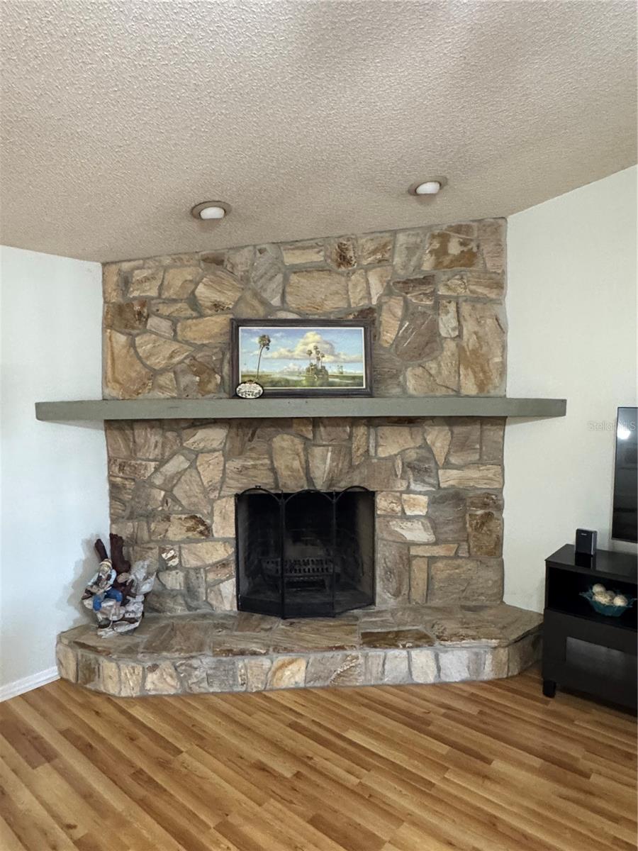 Floor to ceiling stone, wood-burning fireplace in family room… you won’t find this in a new home