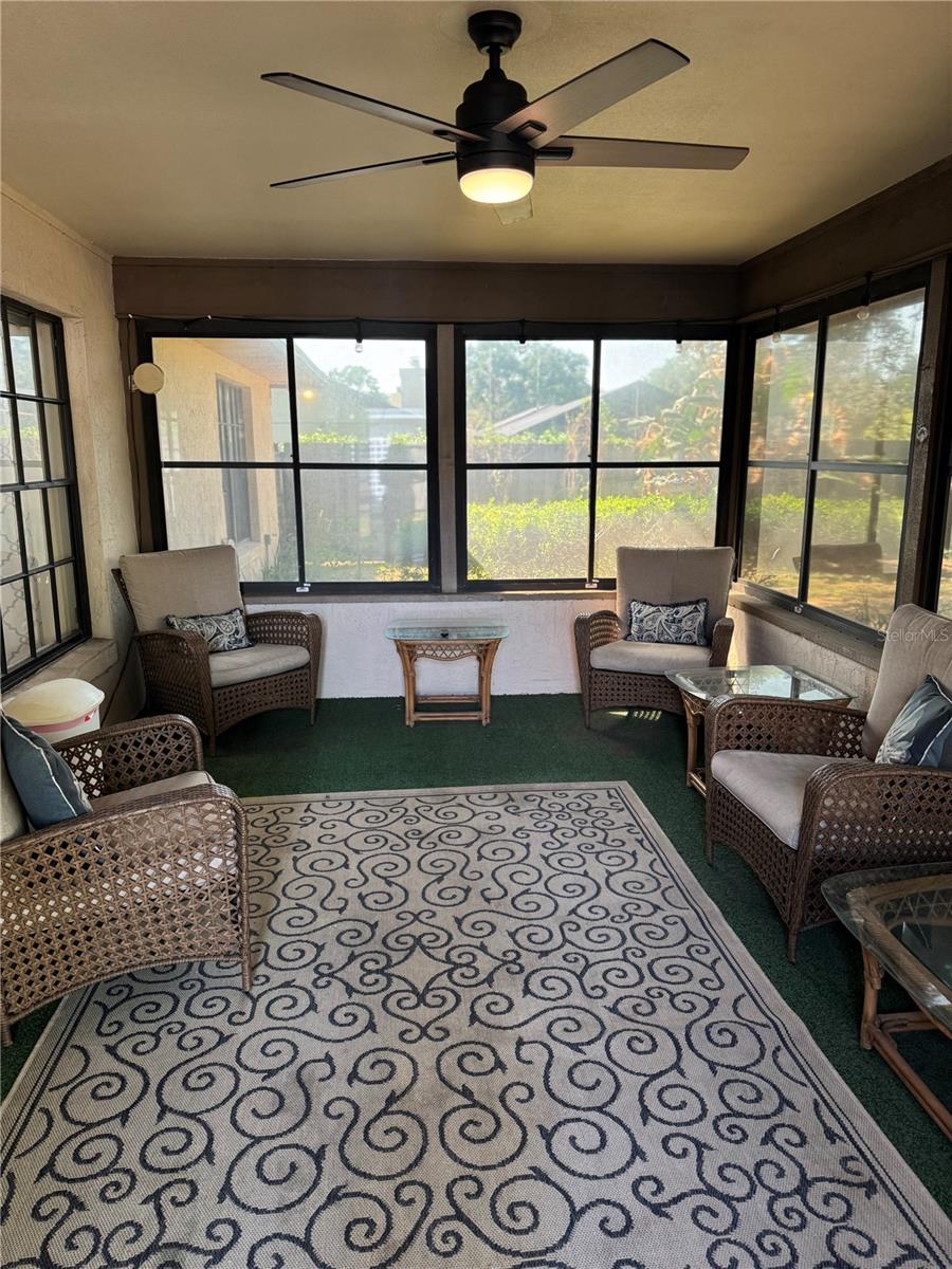 Large covered & vinyl window enclosed Florida room