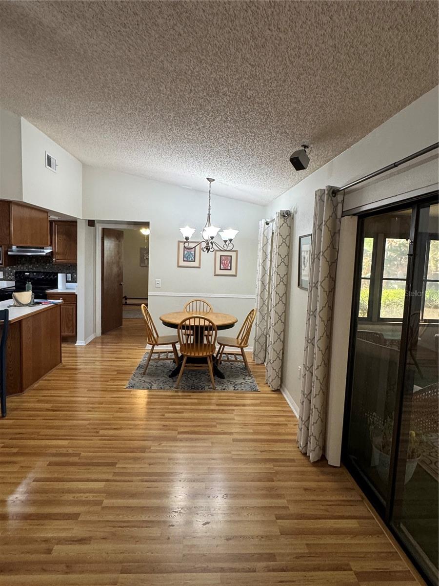 Family room off eat in kitchen with laminate flooring for easy maintenance