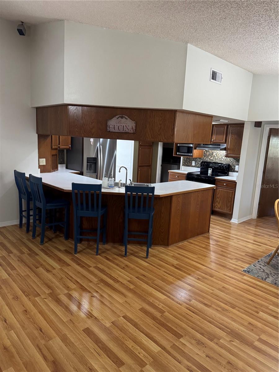 Solid wood cabinetry with flat island in kitchen