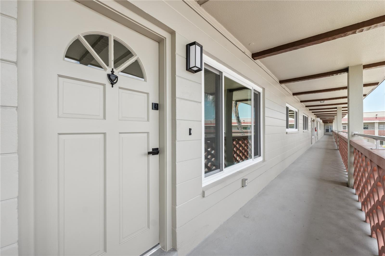 spacious front entrance with room for small patio table & chairs