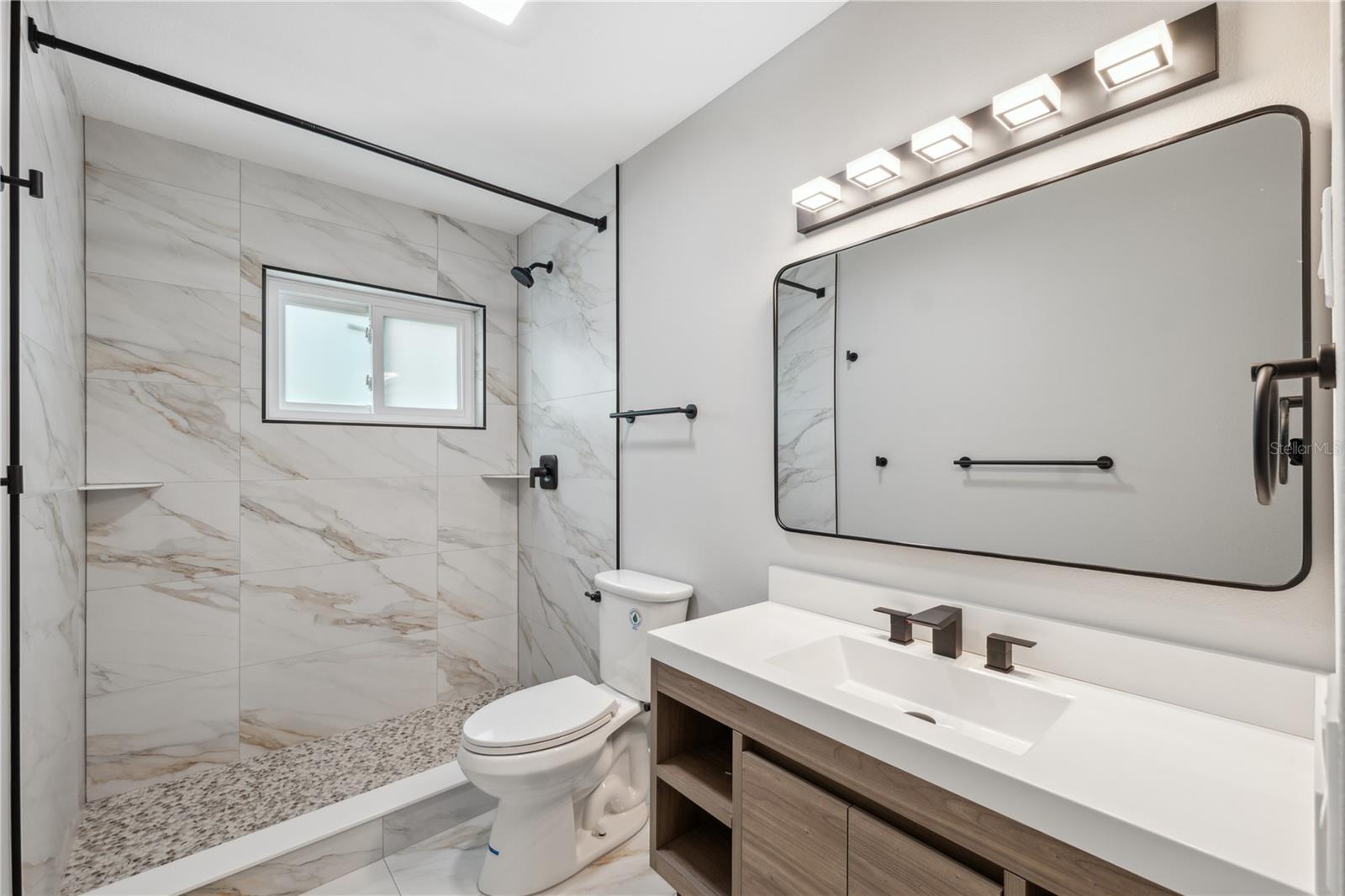 spa like master bath with huge walk in shower and floor to ceiling tile