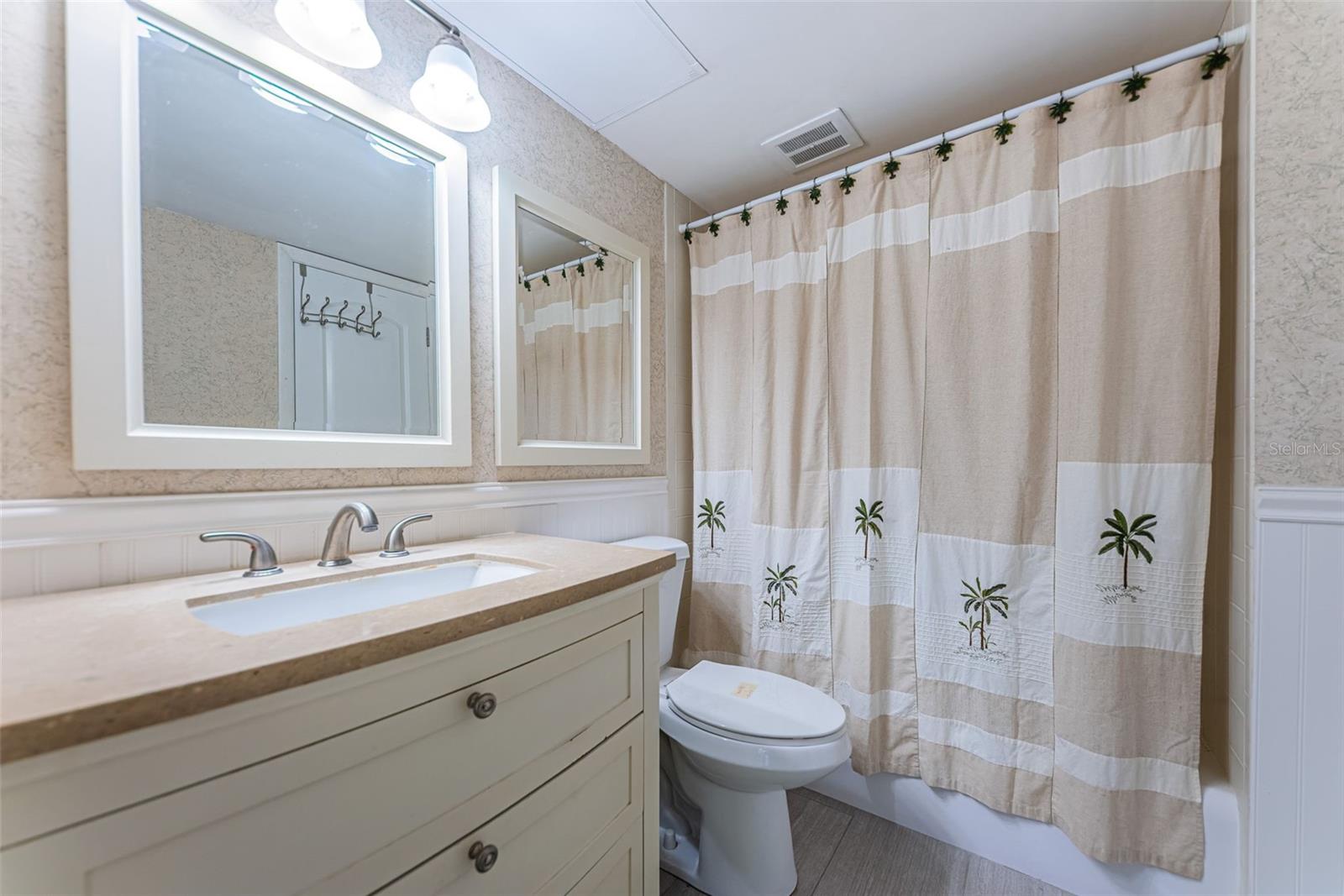 Bathroom with new vanity and high rise toilet