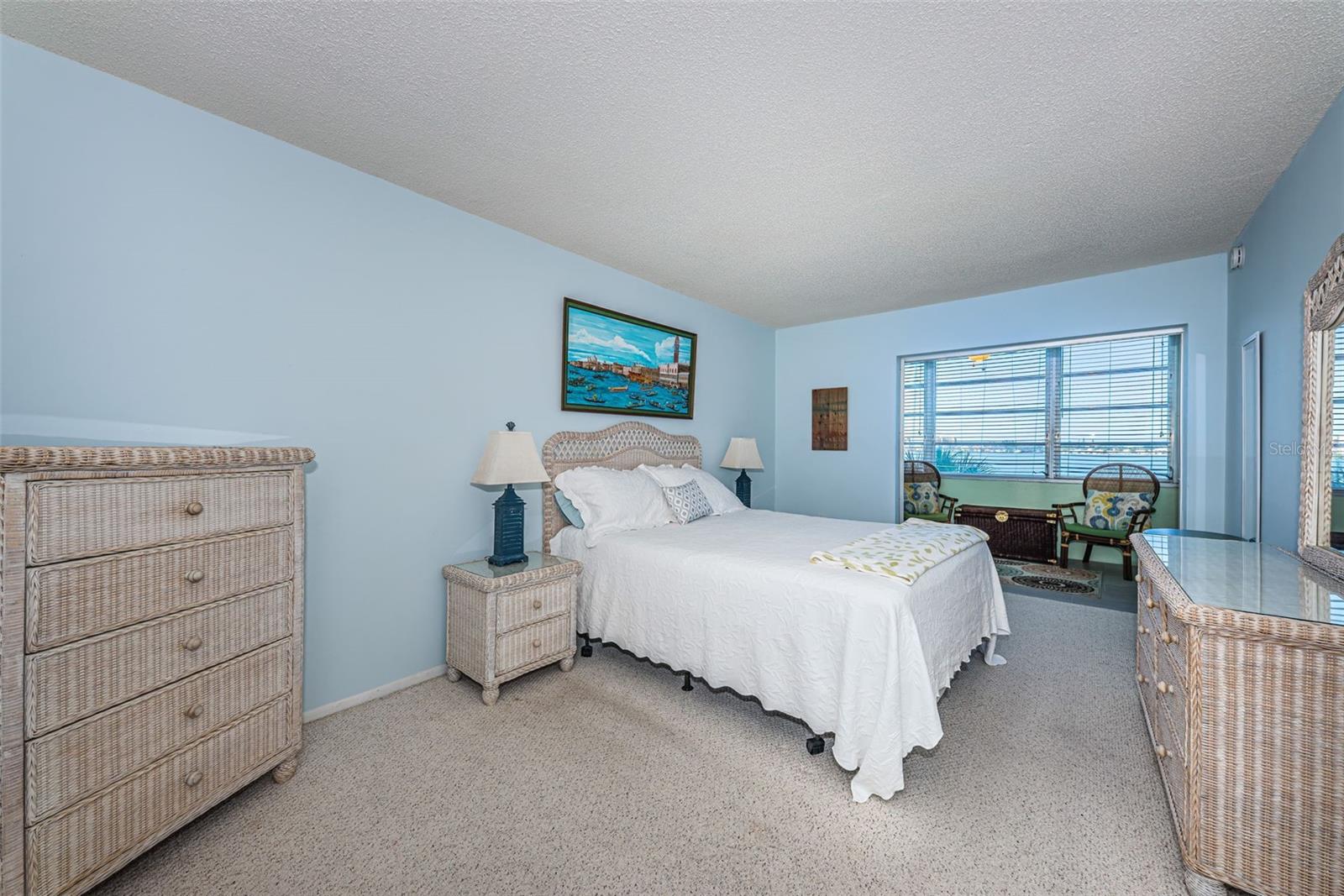 Bedroom with access to sunroom and water views