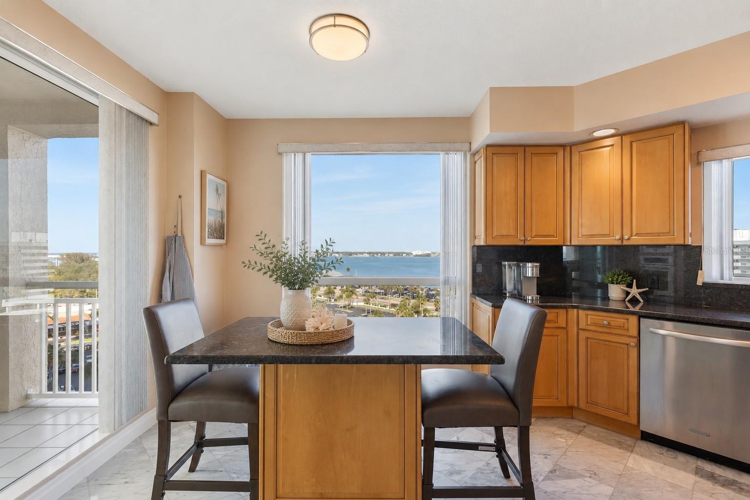 AI Staged. A bite of breakfast looking out toward the calming waters of the Intercoastal waterway where little ones learn to sail, boats head out to prime fishing spots and jetskiers fly past!