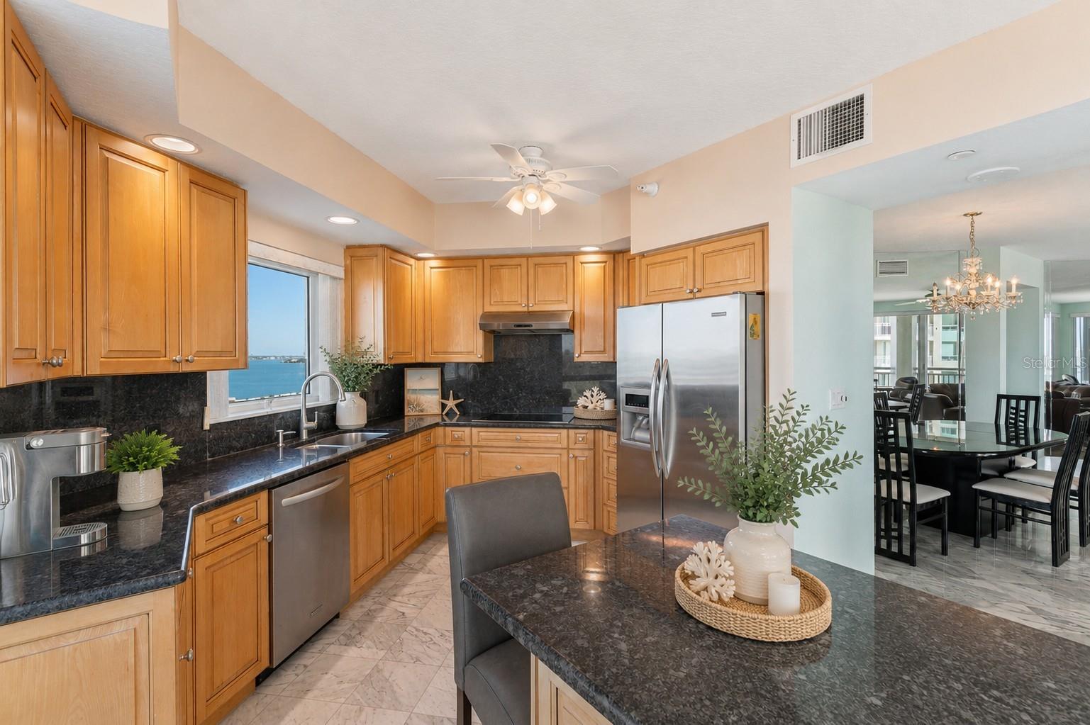 AI staged. Lots of space to maneuver in this large kitchen!
