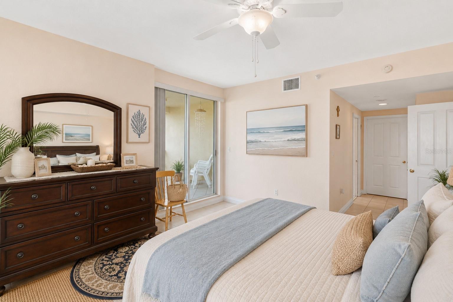 AI staged. Step out onto your balcony for a sip of morning coffee as you watch the sun rise over the water.
