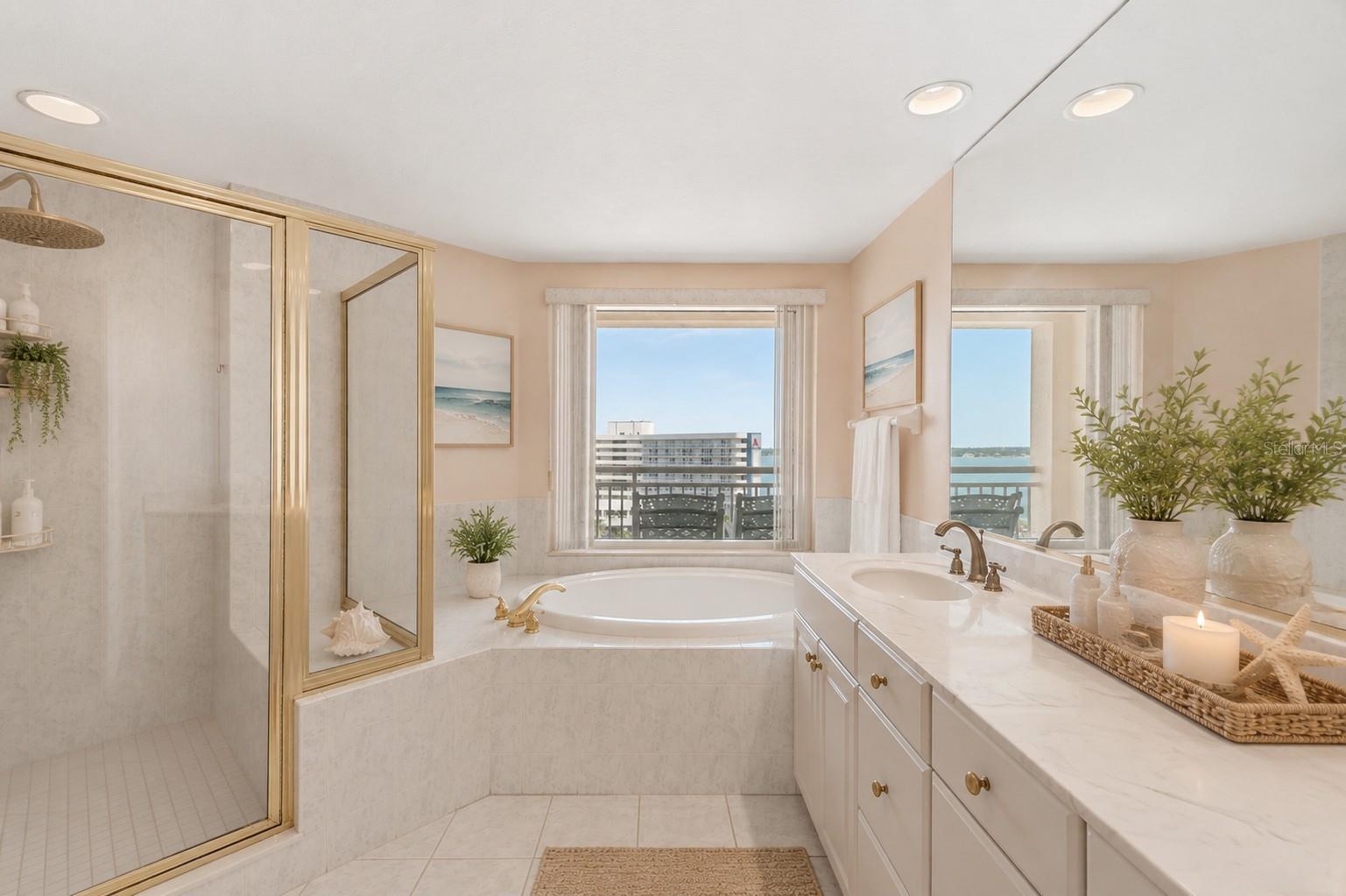 AI Staged.  An oversized master bath with a large shower, tub and space to get ready! .... and yes, more water views!