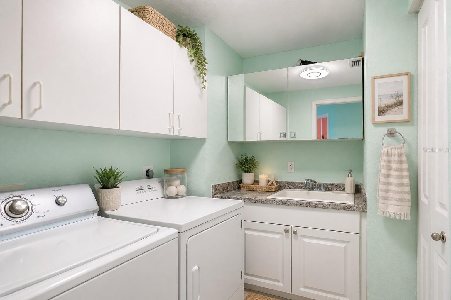 AI staged. A full-sized washer and dryer and a deep laundry sink. This is not your average Florida condo!