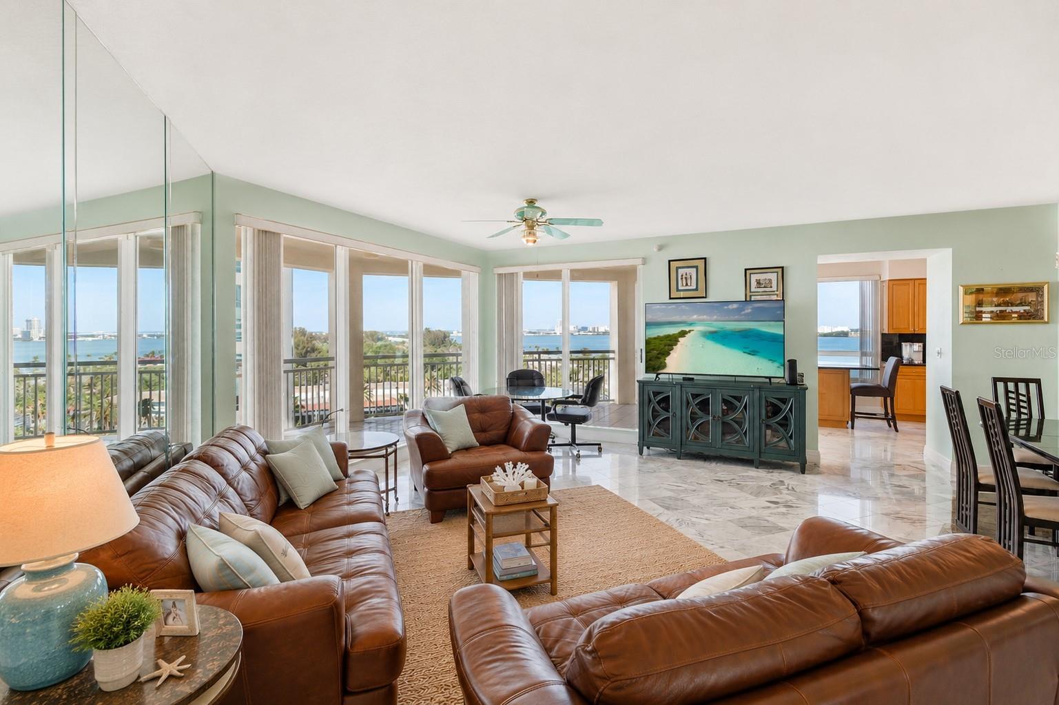 AI Staged. Living area with massive windows and luxury views.  THIS is coastal Florida. This is The Grande on Sand Key....