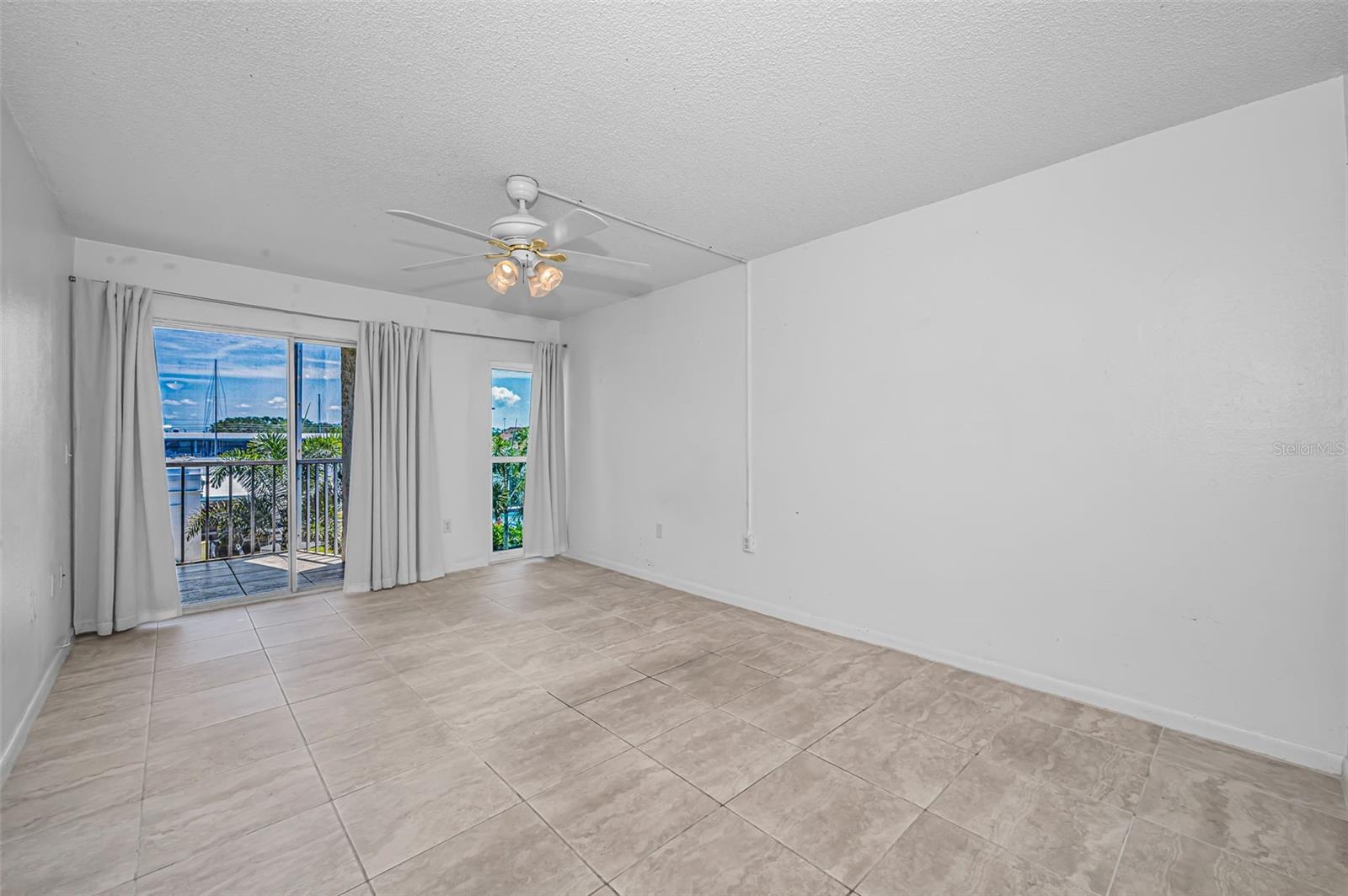 This spacious Bedroom offers more natural light and access to the balcony.