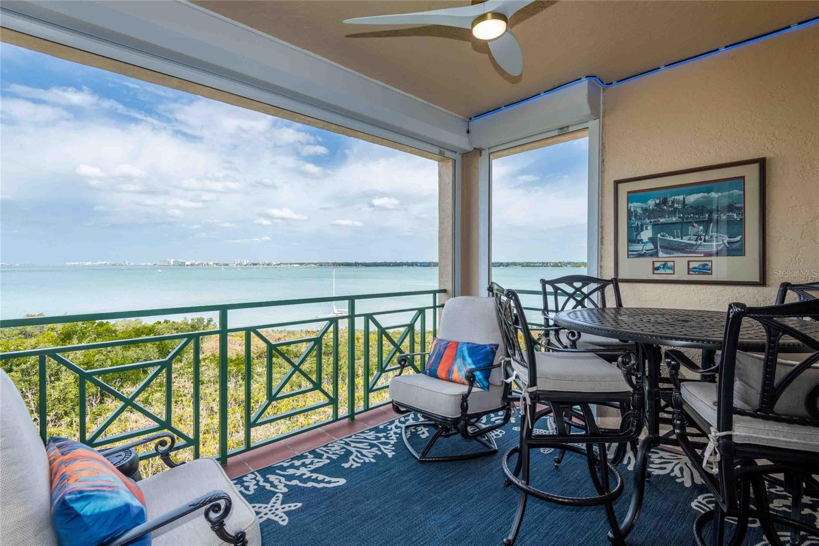 Covered balcony with gorgeous views of Boca Ciega Bay, a new fan, new hurricane sliders and hurricane shutters