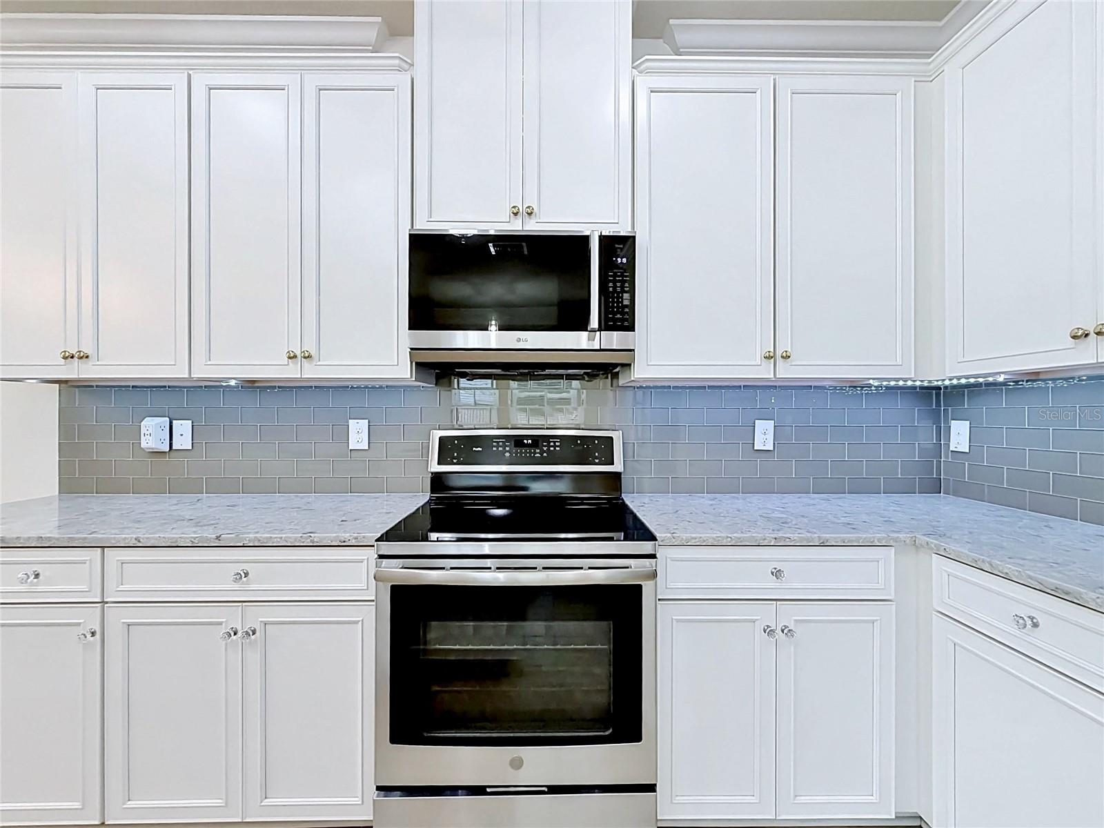 Kitchen has upgraded appliances, granite counters, tile backsplash