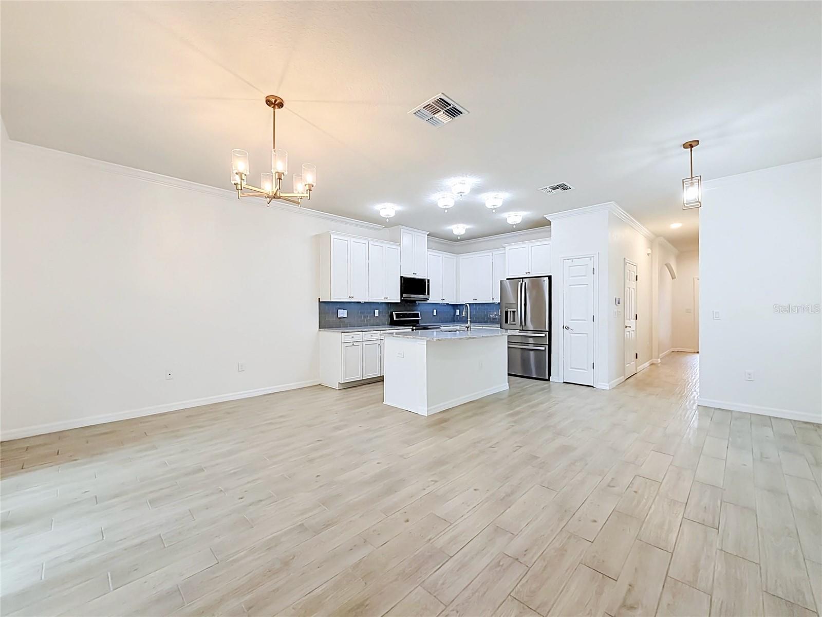 Open concept layout w/ high ceilings & crown moulding