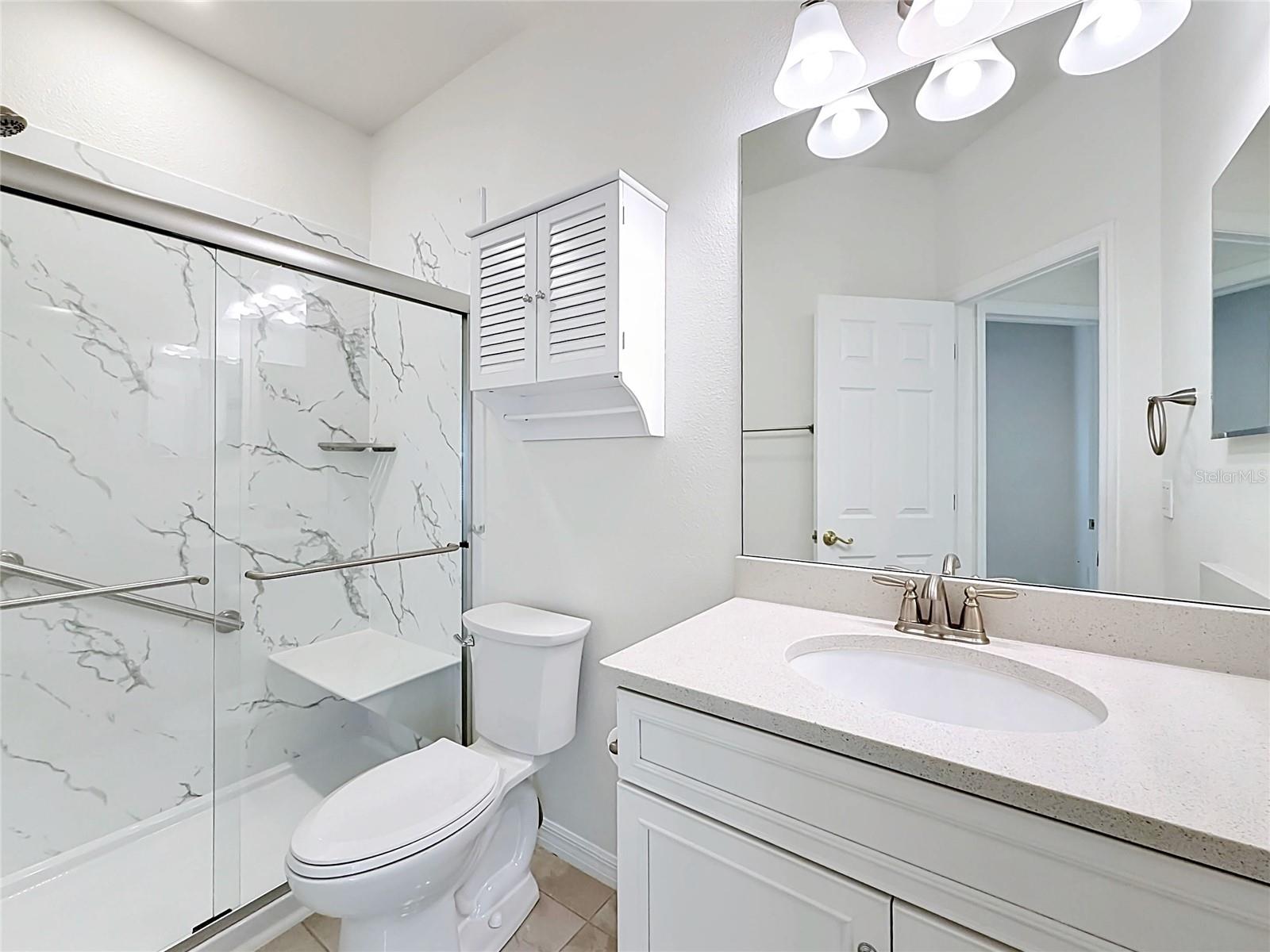 Newly renovated guest bath w/ step in shower & glass door