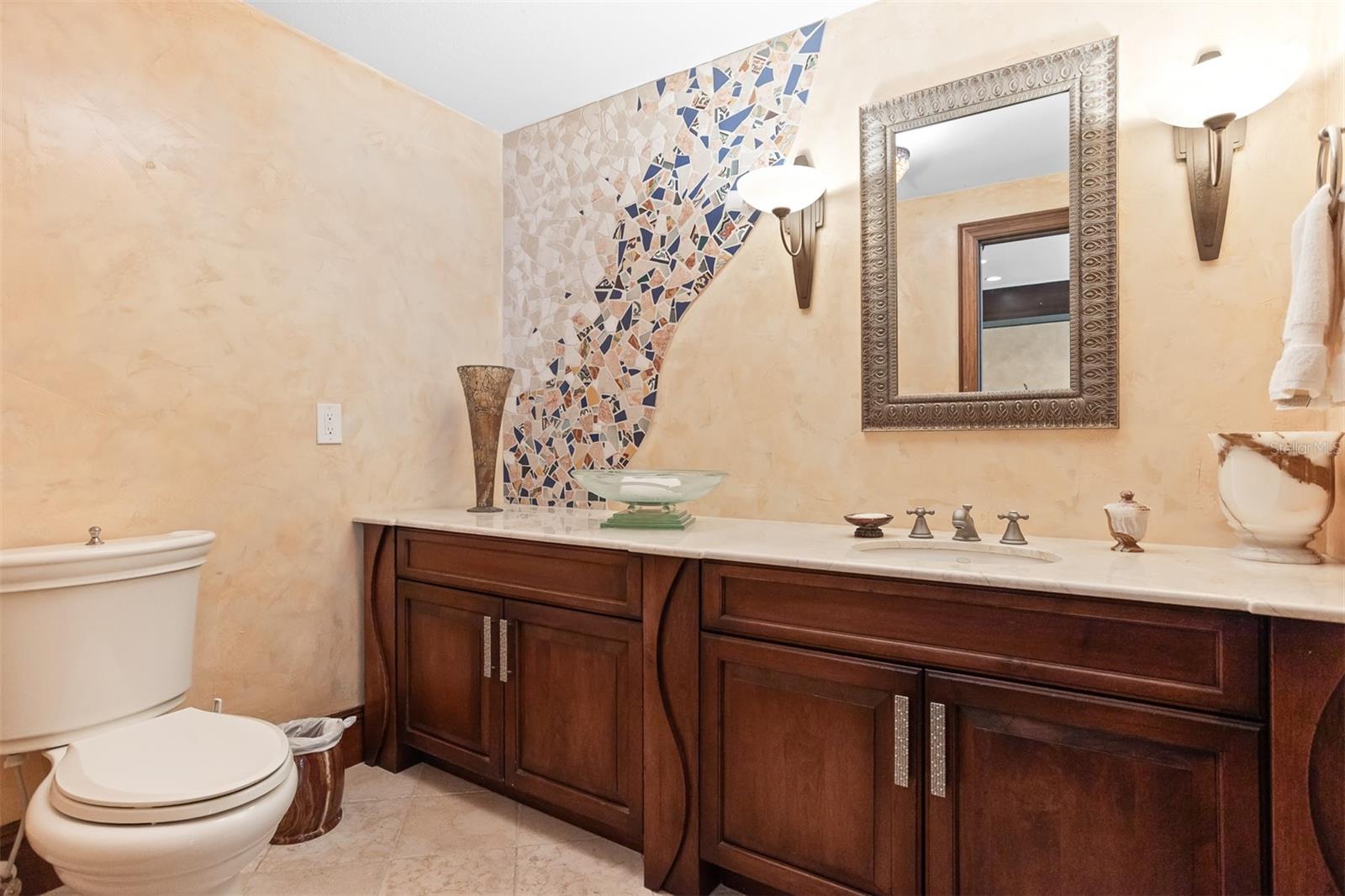 Artistic tile details make this powder room an experience on the North East side!