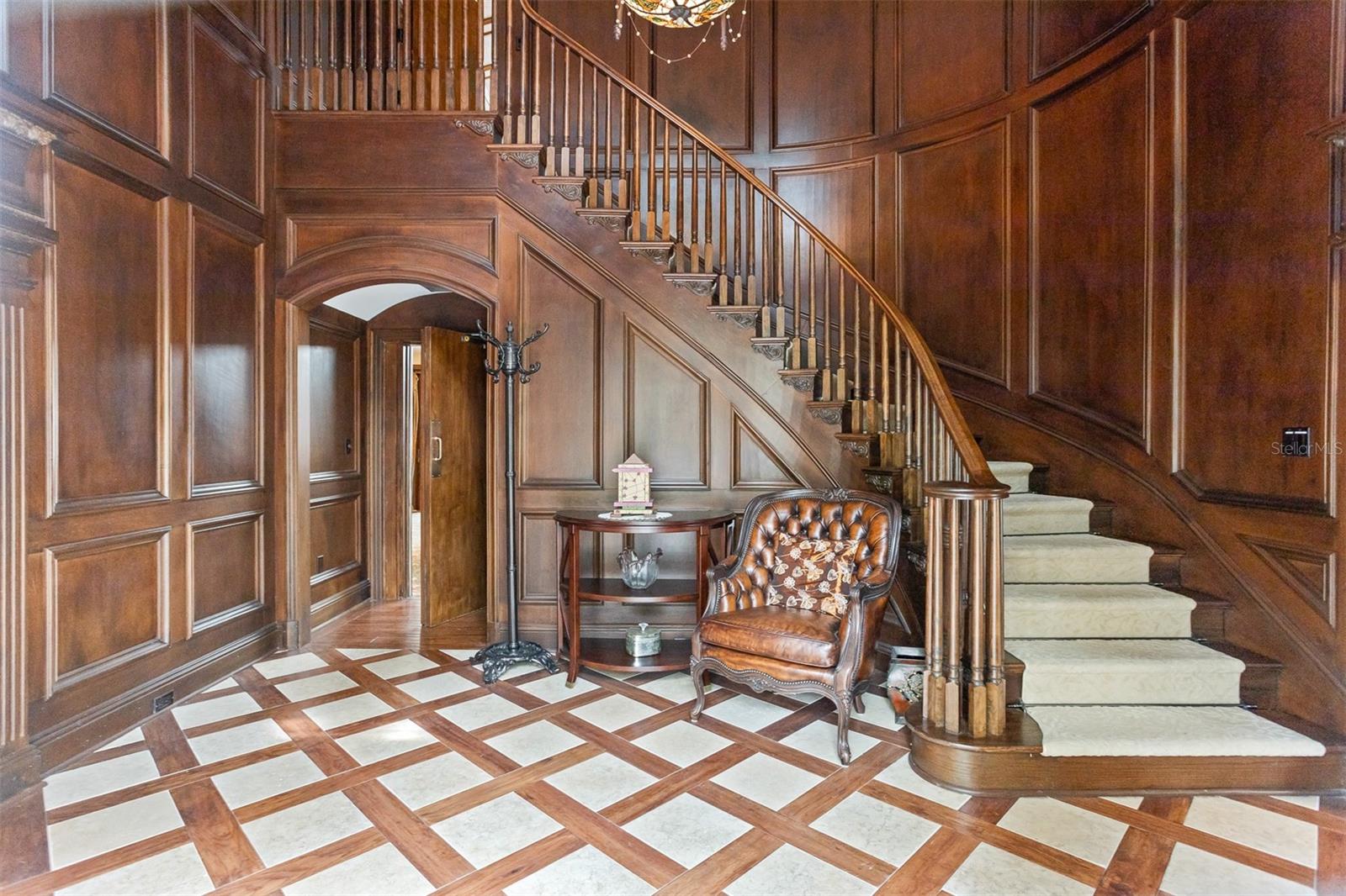 The customized wooden entry feels like a scene out of a movie with rich warm tones offering a great sense of arrival and sets the tone for the rest of this stunning home!