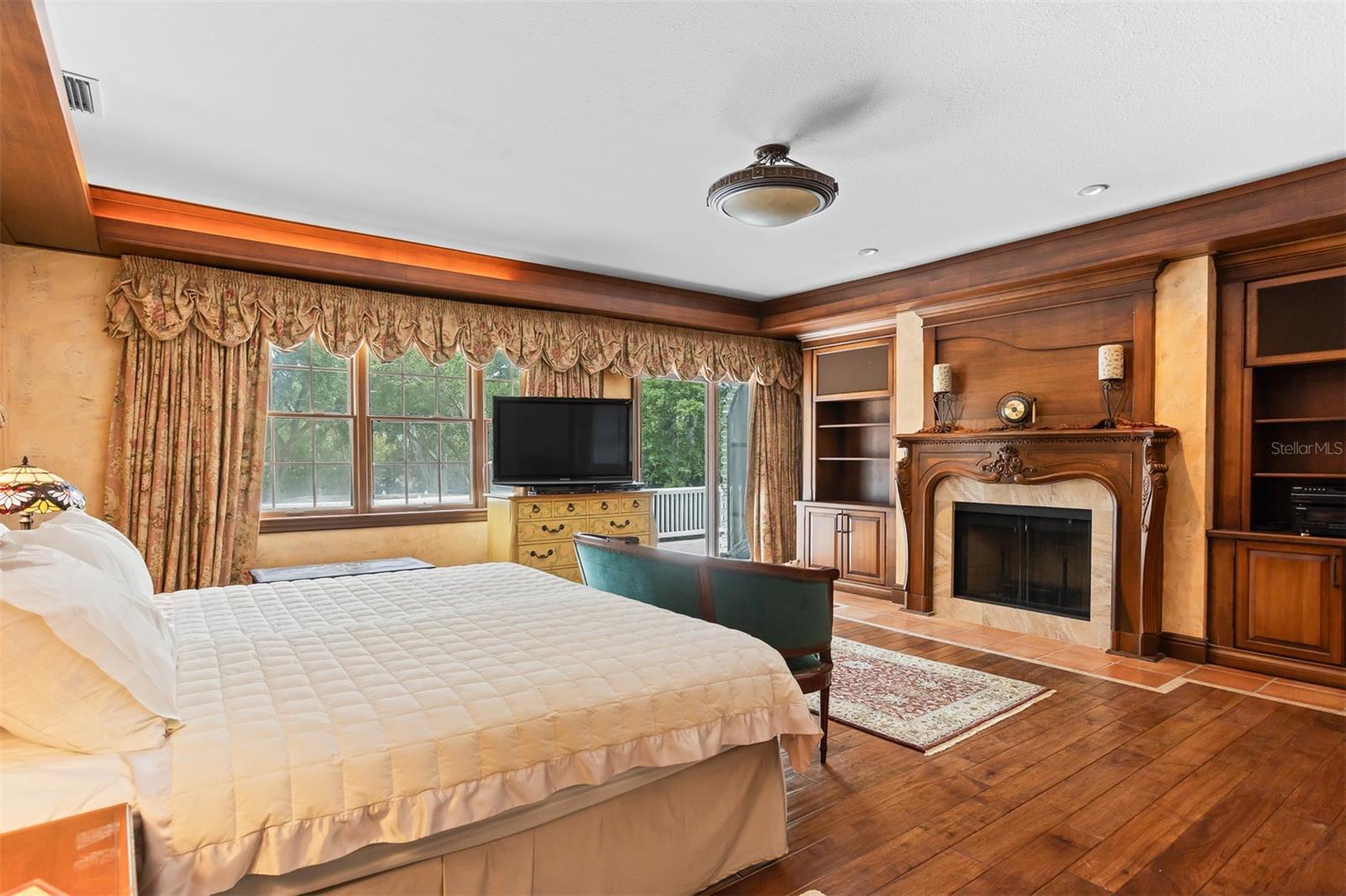 Primary suite with fireplace, natural light, built-in bookshelves and beyond!