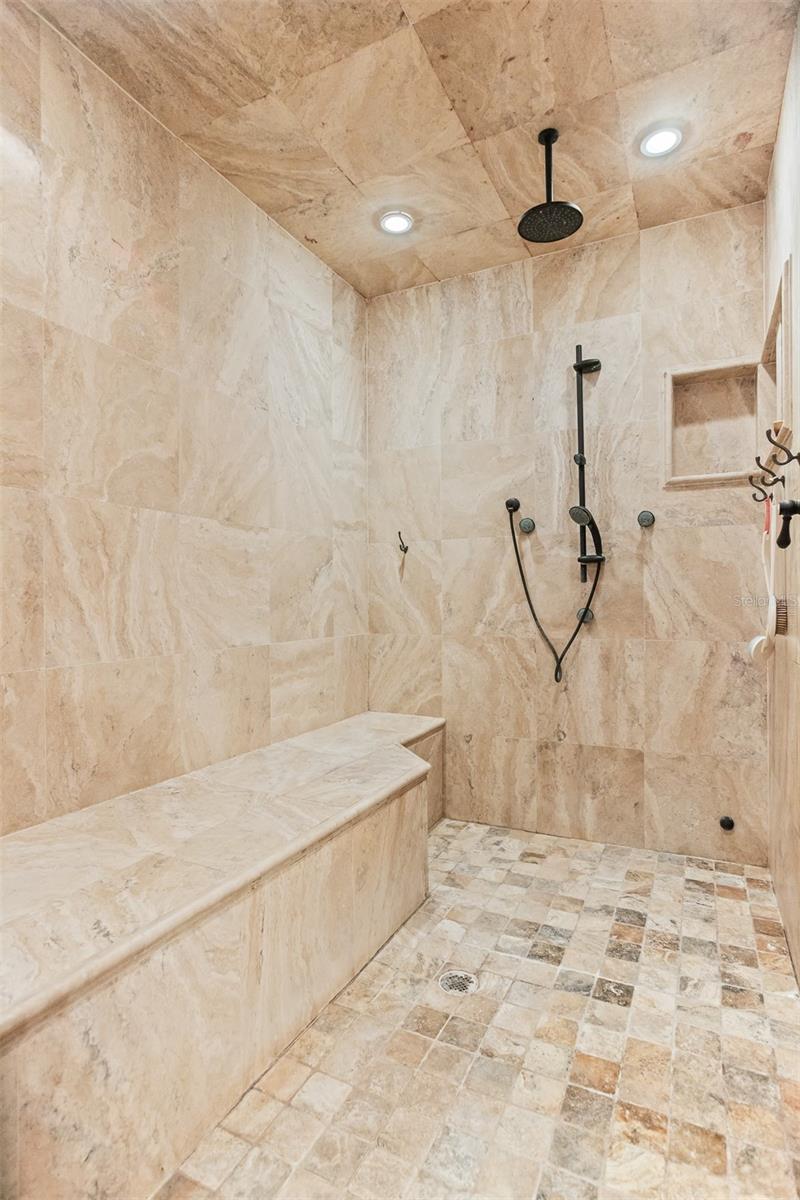 Large Walk-In Shower with multiple shower heads, customized built-in bench makes this a perfect luxury retreat