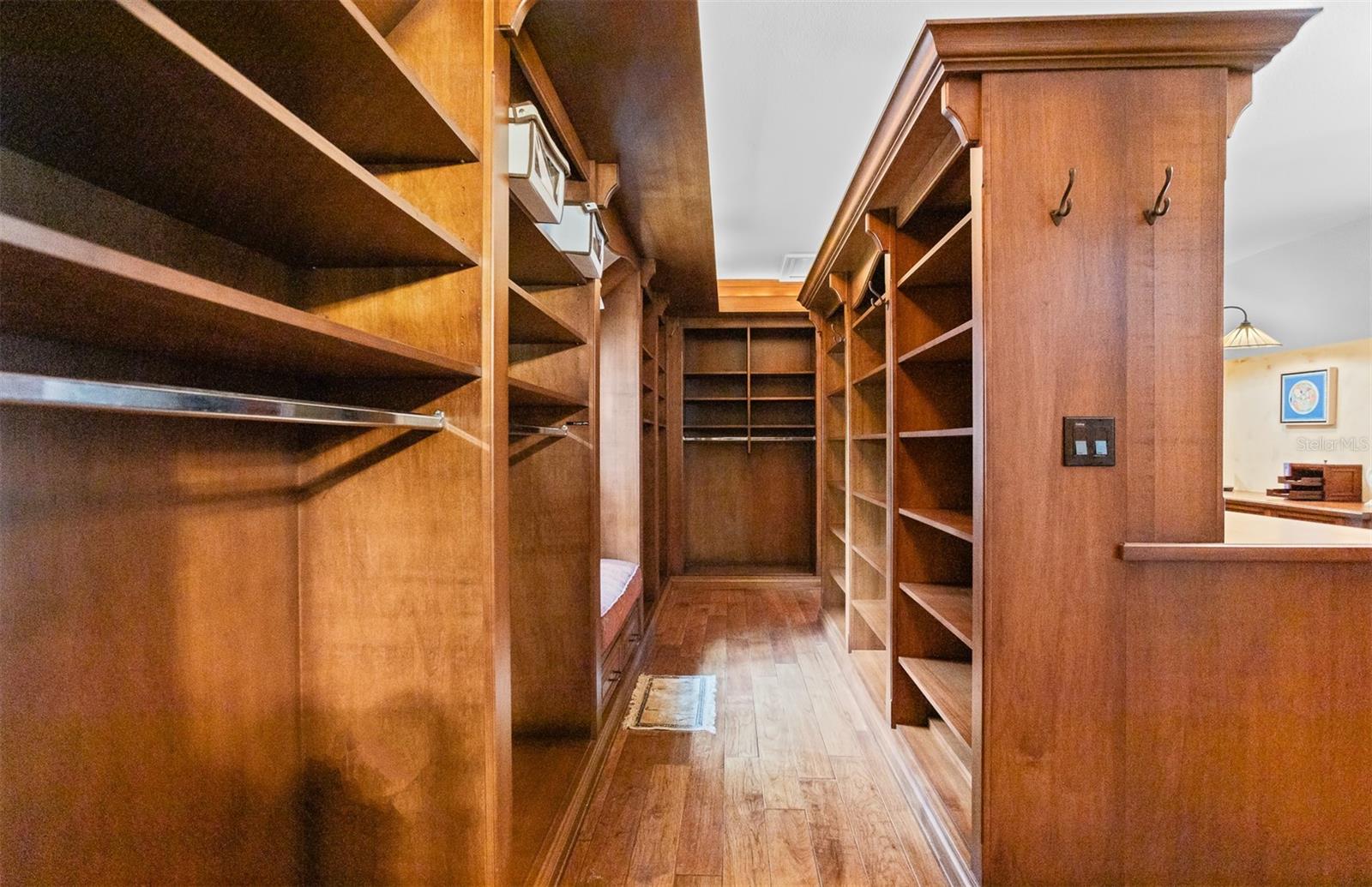 Customized Wood Primary Closet with Elegant Built-Ins