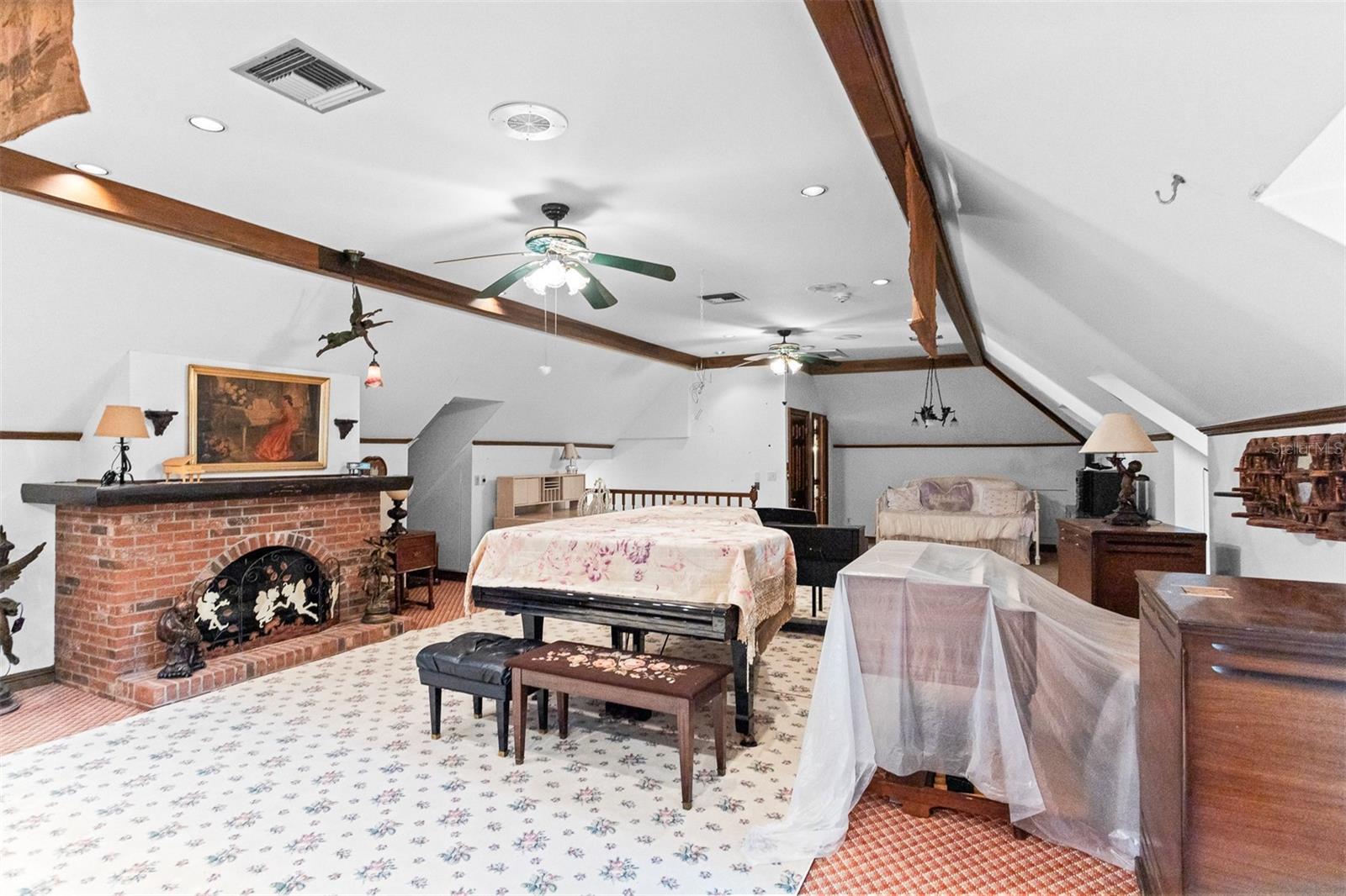 This generous third floor retreat is a warm, private space complete with a fireplace and its own attached bathroom, perfect for a guest suite, home office or creative hideaway.