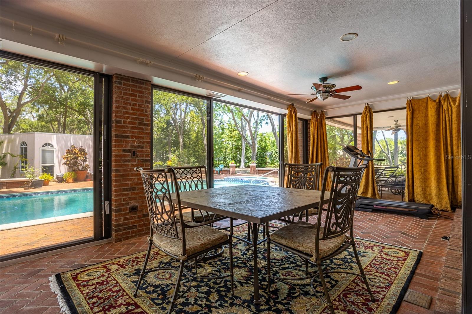 This beautiful lanai floods the room with light and also frame a gorgeous view of the pool and backyard creating  perfect blend of relaxation and privacy.