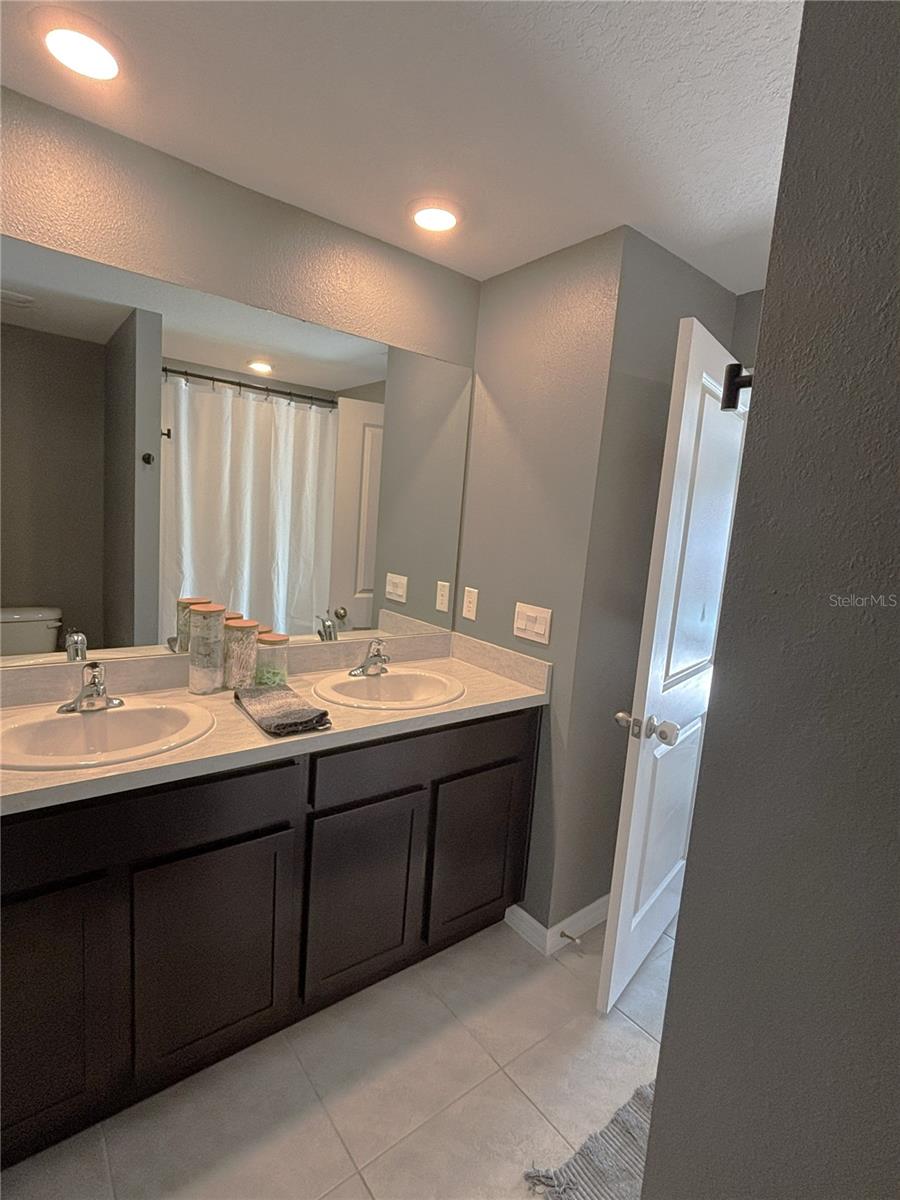Primary En-Suite with Dual Vanity and Linen Closet.