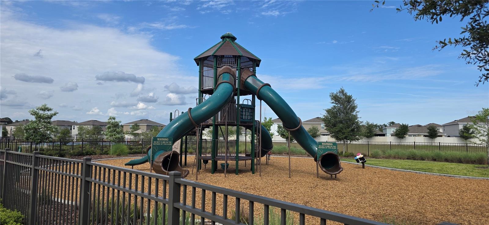 Community Playground, Gated and Fenced, with Swings and sitting areas.