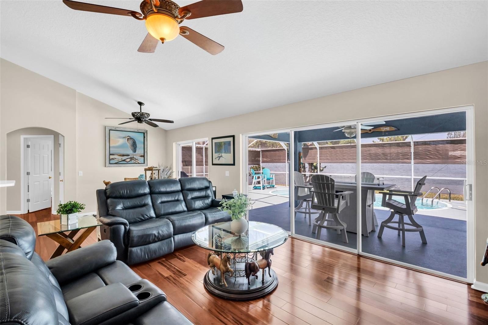 Light & bright main living with triple glass sliders overlooking the pristine pool~